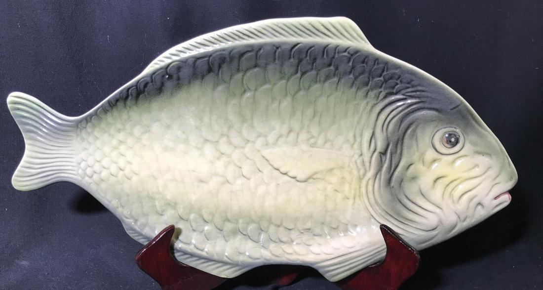 Mighty Fish Ceramic Dish Platter: Serve your cut, fried, fresh fish on this clever serving platter. Ceramic is molded to show fish scales and fins. Measures 18.5 in. long, 9.5 in. wide. Imprint on underside is illegible. No chips or c