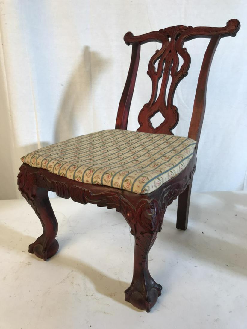 Vintage Doll’s Chair W Claw-and-Ball Feet: Vintage dill’s chair with Upholstered seat on carved wood frame. Ball-and-claw front feet. Red tone wood frame and patterned upholstery on seat. Measures approx 18 inches in height by 11.5 inches in