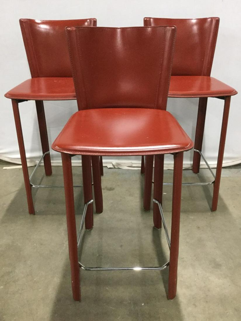 Set 3 Metal Bar Stools W Leather Coverings: Lot includes 3 metal chairs, each have red toned coverings, possibly Genuine leather. Each chair has 4 legs. Each Measures approx 37 inches tall 16 inches wide, 20 inches deep. bar stools, home furnis