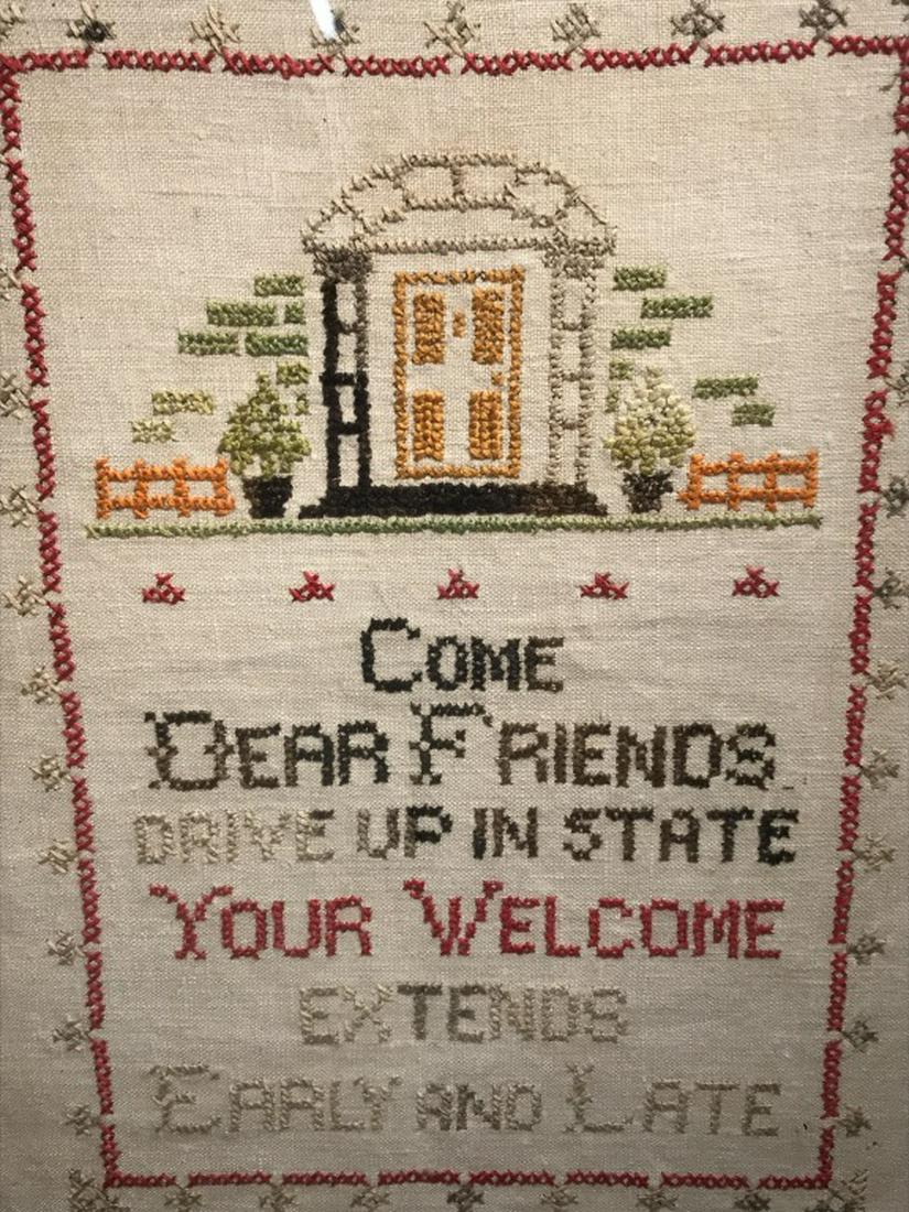 Vintage Motto Sampler W Doorway Motif: Sampler features the saying ‘Come dear friends drive up in state/ Your welcome extends early and late.’ Embroidered doorway motif with patterned border. Sampler is set behind glass in wood frame.
