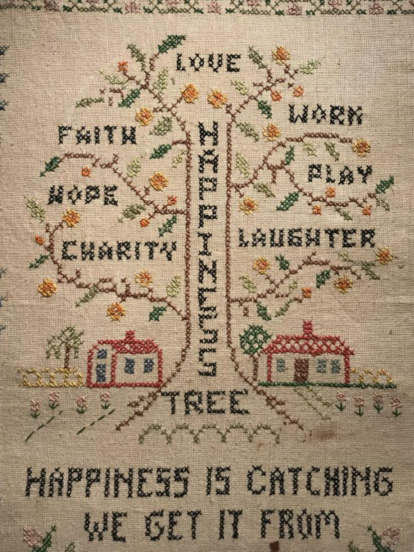 Vintage Motto Sampler W The Happiness Tree Motif: Sampler features embroidered happiness tree motif with branches for charity, hope, faith, love, work, play, and laughter, along with the saying ‘happiness is catching we get it from one another.’
