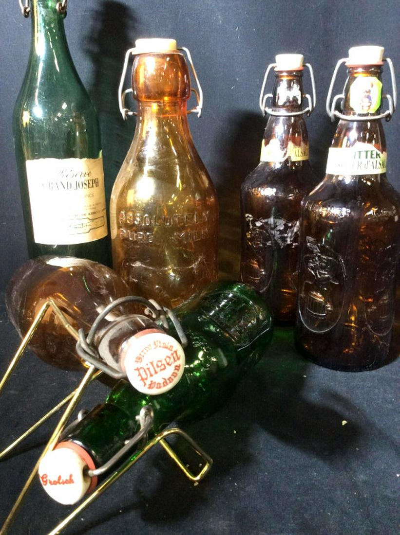 Vintage Wine, Beer & Milk Bottle Collection 6 pcs: Mostly European Marks. All have Bottle stop with latch. Reserve Grand Joseph - Bottle Measures 13.5 in. H 3 in. Circumference. Absolutely Pure Milk Bottle with Cow on the front, approx 10.5 in. H 4 in