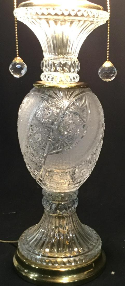 Cut Glass Relief Dual Light Table Lamp: Pull chain for on/ off. Gold tone accessory decor. In working condition. No scrapes or nicks on glass. Match crystal ball finial ( matches pull chain ball ends). Approx 30 in. H. Comes with shade or y