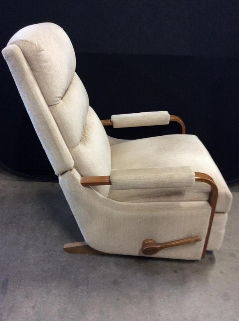 Mid Century Modern Style Recliner: Recliner has mid Century Modern Style. Piece Is tan toned with light brown toned wooden frame. Piece measures approx 39 inches tall 27 inches wide, 35 inches deep. MCM, mid century modern furnishings,