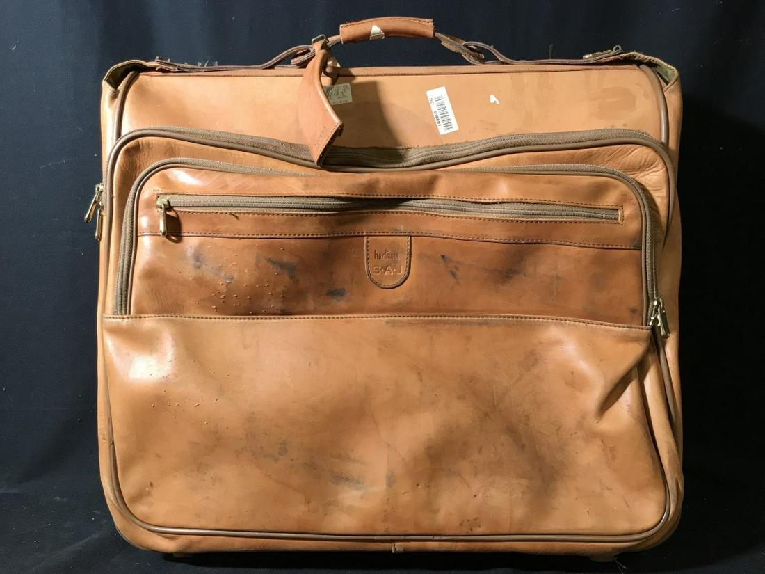 HARTMANN Leather Suitcase W Wheels, Used: Used HARTMANN leather suitcase with wheels and expandable handle. Marked for Hartmann, along with initials SAJ. Suitcase measures approx 21 inches in height by 23 inches in width by 9 inches in depth.