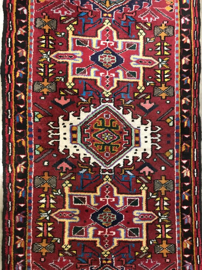 Vintage Handmade Geometrically Detailed Wool Rug: Piece contains tones of yellow, cranberry, cream, navy, forest green, black, pink, light blue and teal. Piece is Fringed. Measures approx 74 inches long 26 inches wide. interior decor, home accessory,