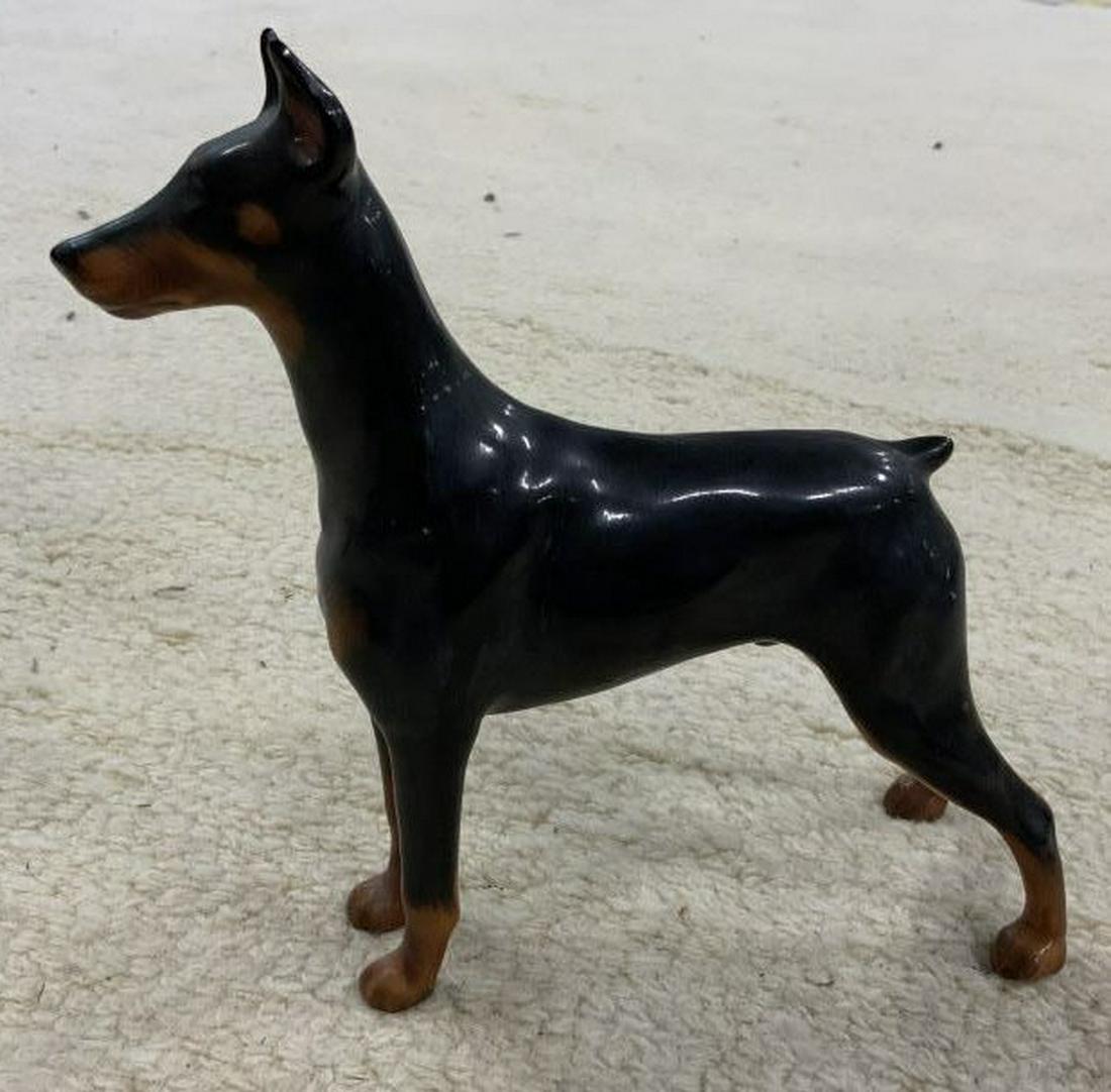 Porcelain Doberman Dog Figural: Vintage porcelain dog figure collectible, possibly Doberman, ht app 6.5 inches length app 6 inches, signed on paws Rancho Dobes Storm, and more illegible