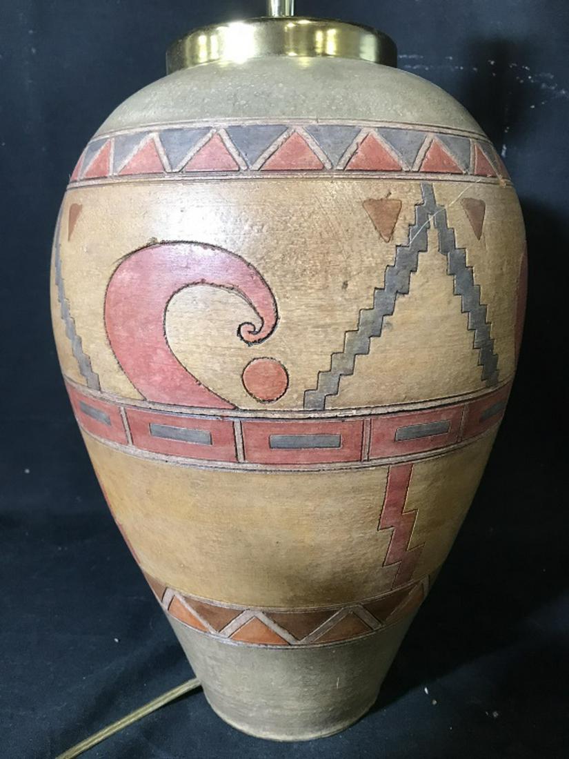 Painted Ceramic Table Lamp: Piece appears to be ceramic. Contains multi toned geometric detail with tones of tan, olive, & red. Measures approx 26 inches tall 10 inches wide. table lamps, home accent and accessories, home lighti