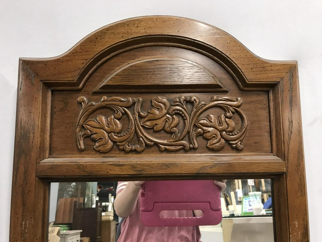 Pair Pier Mirrors W Arched Tops & Floral Detail: Pier mirrors are set in wood frames with arched tops with leaf & vine details in relief. Each measures approx 45 inches in height by 19.5 inches in width. Some light scratches on frames. Pier mirrors,
