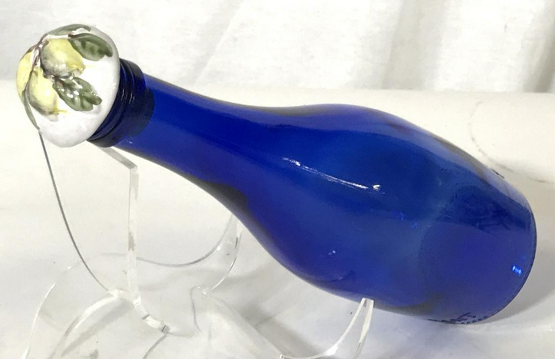 Cobalt Blue Glass Bottle with Decorative Cork: Markings on the bottle- TY NANT. It was a sparking spring water bottle from Wales. Holds 330 ml. Underside markings include various numbers & symbols; N1, 20, 52 mm, €, symbol that resembles a 4 dic