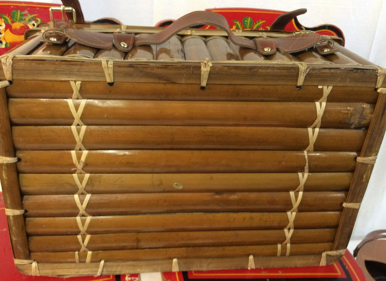Hawaiian Picnic Basket with Extras Likely Never Used: Likely Never Used Basket. Additional Boxes Never Opened. From Picture, looks to be Plates, Utensils, and more. Basket is Fabric Lined with Rattan - like Material. Buckles Closed. Has Carry Handle 18 x