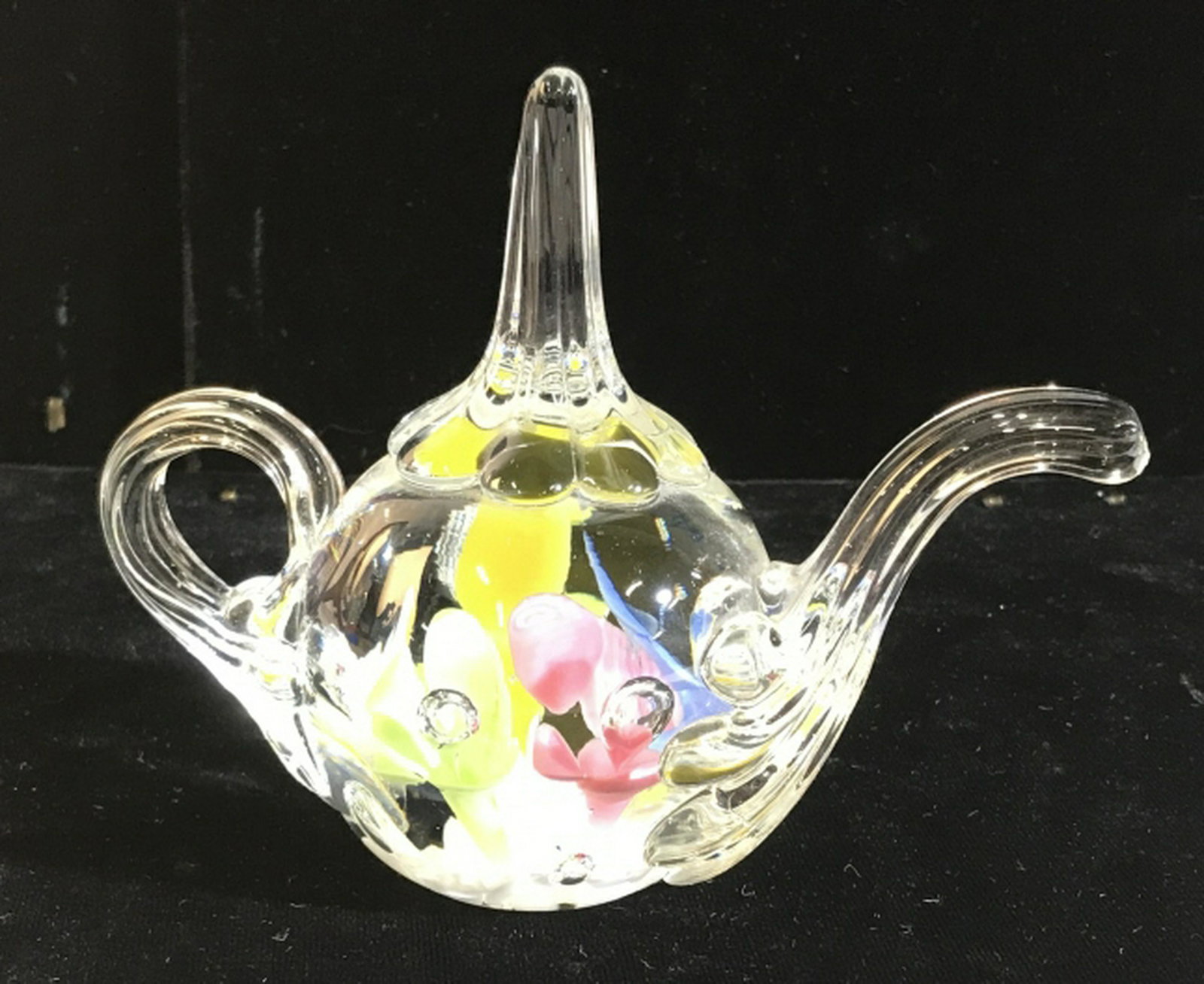 Joe St. Claire Art Glass Tea Pot Paperweight Budding: Budding colorful flowers rise inside teapot. Approx 4.5 in. height, 5.5 in. long. Marked Joe St. Claire On Underside. No chips. In very good condition. St. Claire Glass, Glass Teapot Paperweight, Art 