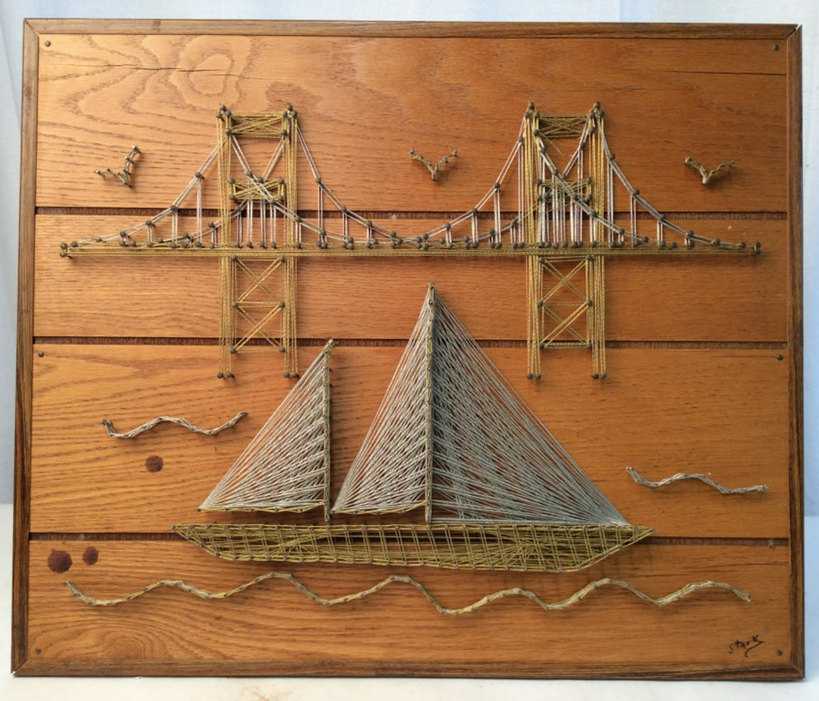 Handmade Bridge & Boats String Art Wall Decoration: Signed Nautical theme scenery string art piece. Materials include silver and gold string held on by metal nails on a hardwood pine board. weaving throughout the nails. Art piece measures at 20.2 inche