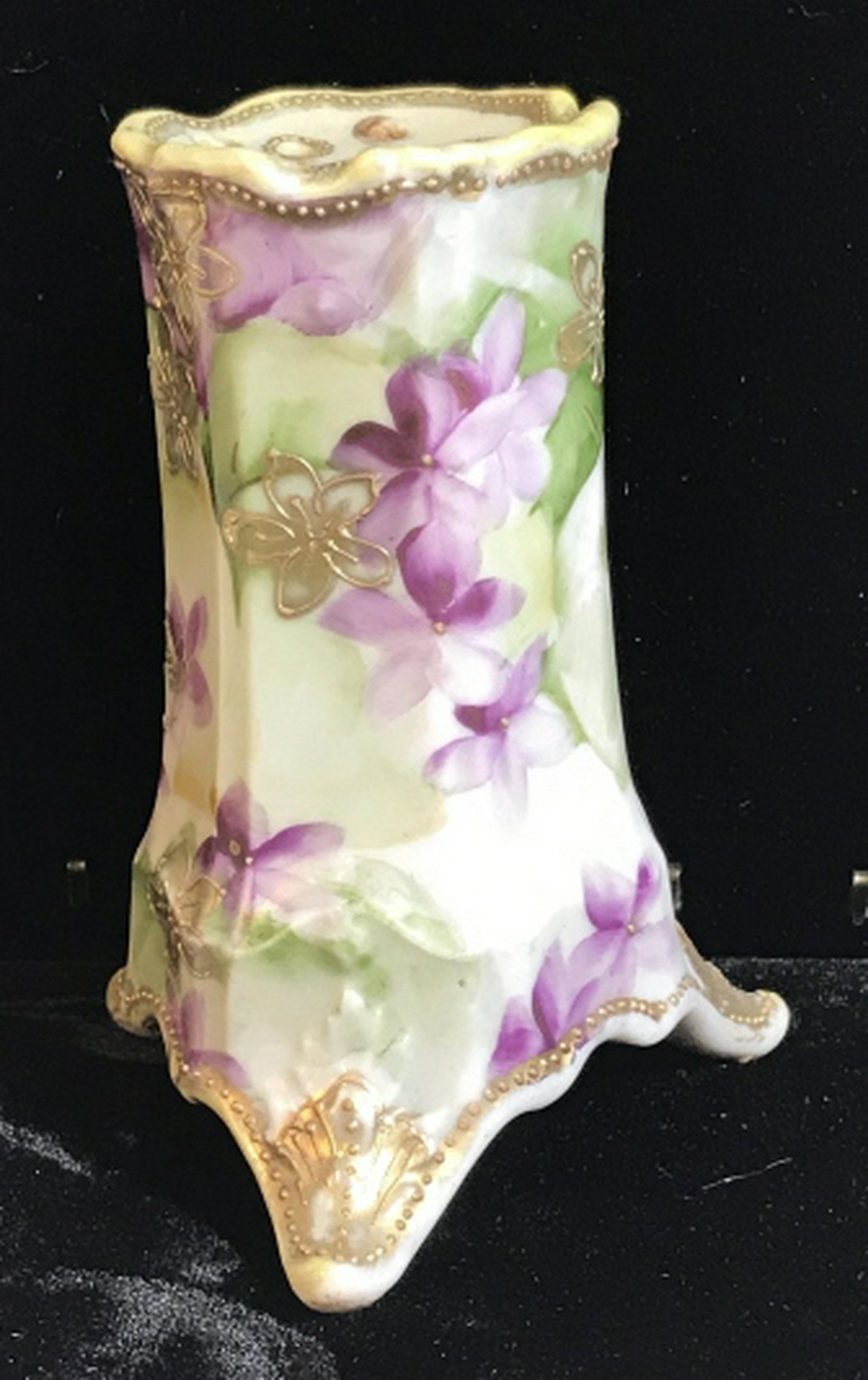 Nippon Hand Painted Porcelain Hat Pin Holder: Floral Motif with thin lines of gold paint. Marked on underside. 4.5 in. tall. 3 footed bottom, 3 in. diameter. A few mild surface issues. Vintage Nippon Porcelain, Nippon Hatpin Stands, Women’s Hat