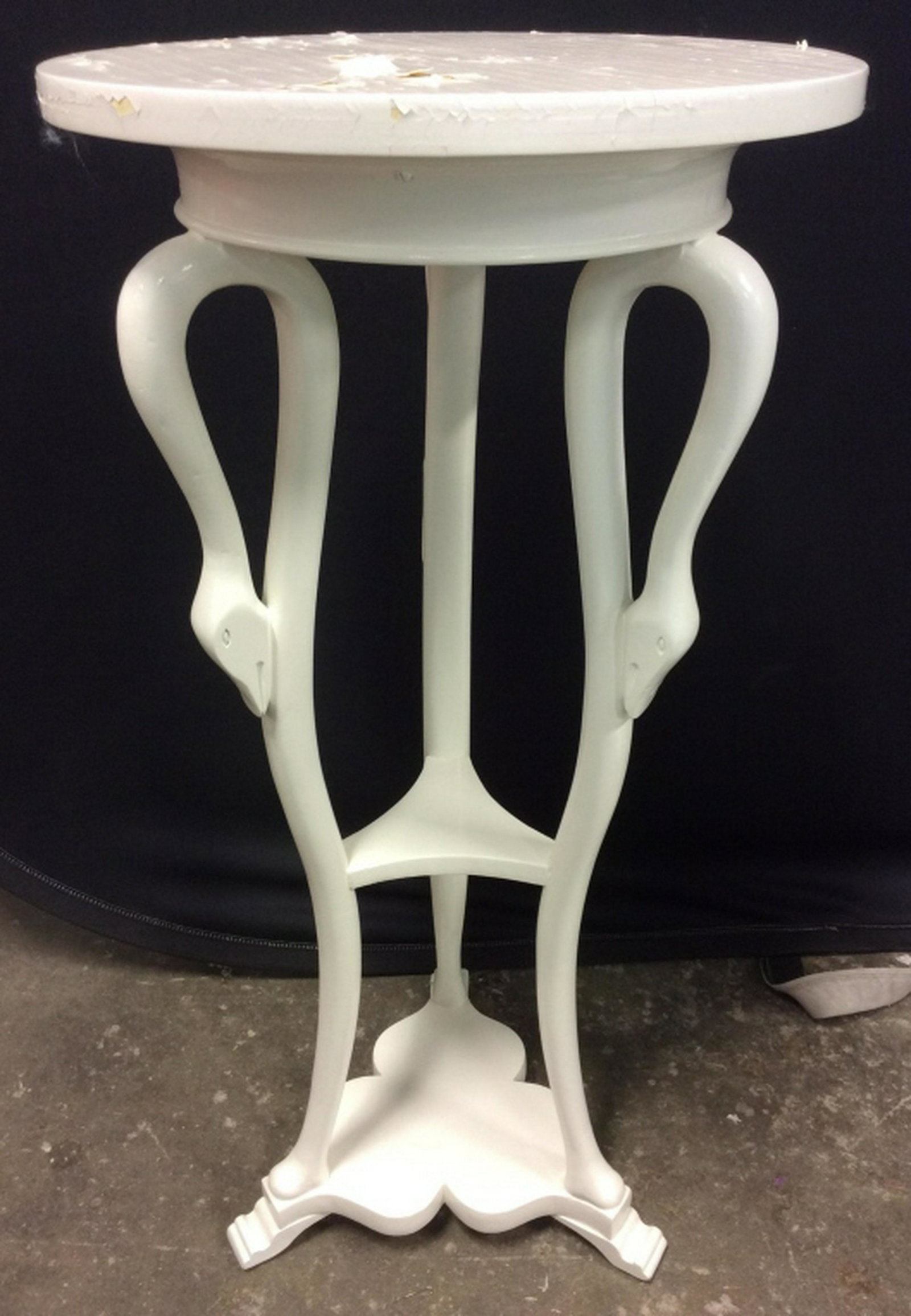 Pair White Toned Wooden Swan Detailed Tables: Pieces are both white toned and wooden. Pieces each have 3 carved Swan Head Figurals. Side tables, round tables, planter stands. Measures approx 29 inches tall 14 inches wide. Appear to be vintage. Pi