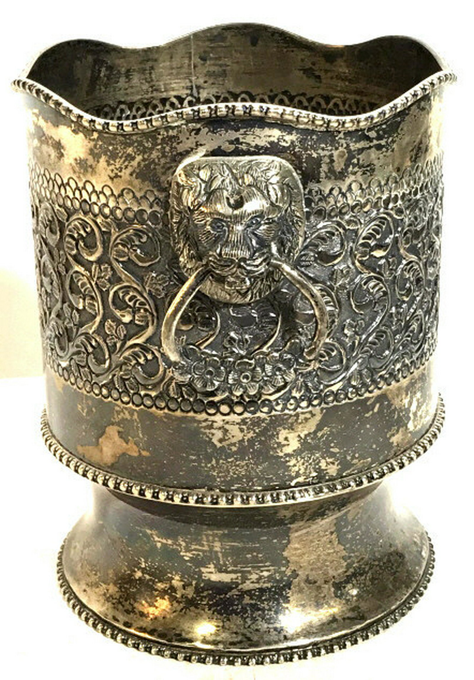 Silver Plated Wine Cooler: Repoussé Metal, with elements of Baroque Style, Bead trim edging & lion decor lifting handles. Interior shelf to separate bottle from ice/ melt. Surface discoloration, possibly needs polishing, appro