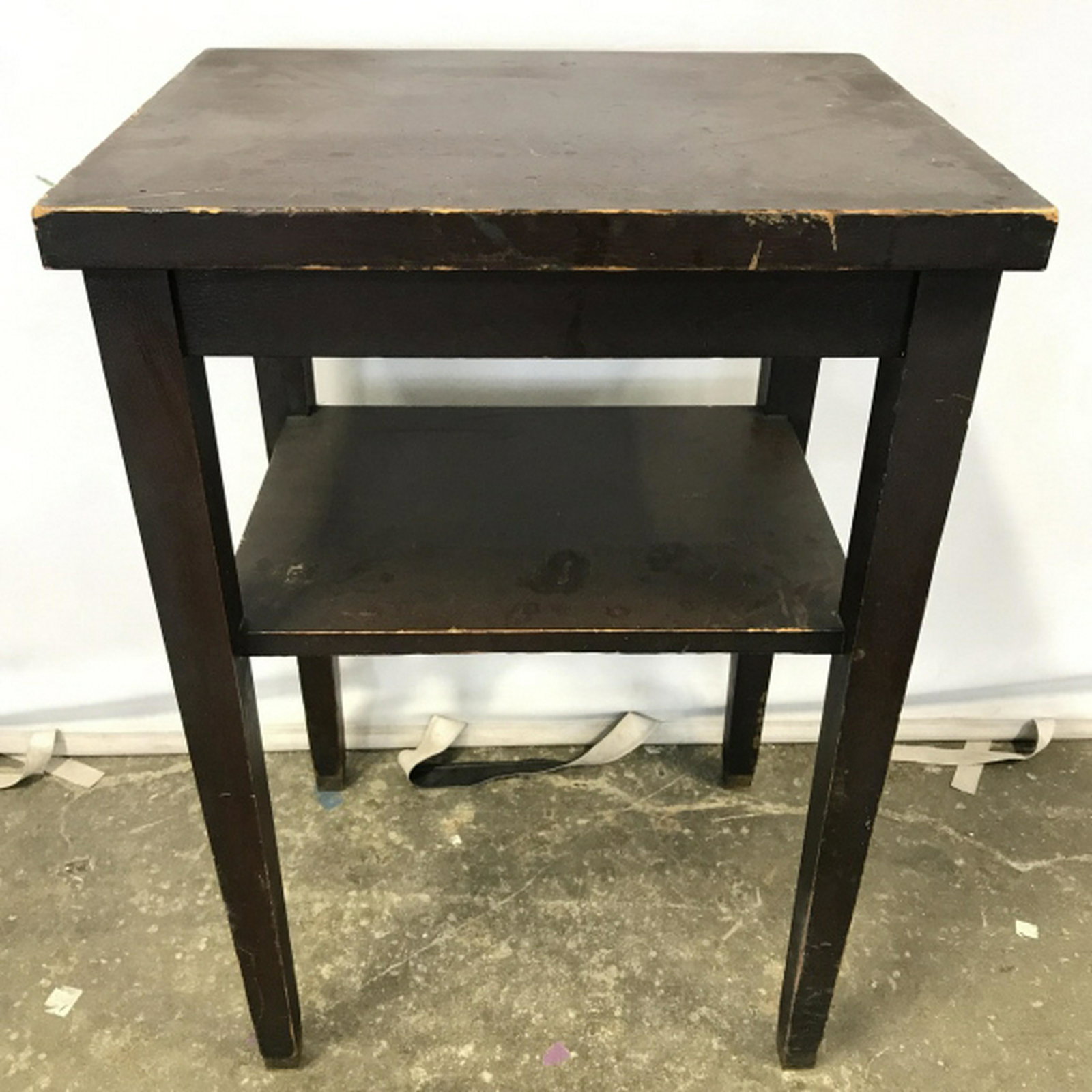 Vintage Dark Chocolate Toned Wooden Side Table: Table has a Dark Chocolate tone. Piece is vintage. Piece has lower shelf area. Measures approx 29 inches tall 20 inches wide 16 inches deep. side table end table home accent and accessories, lamp tabl