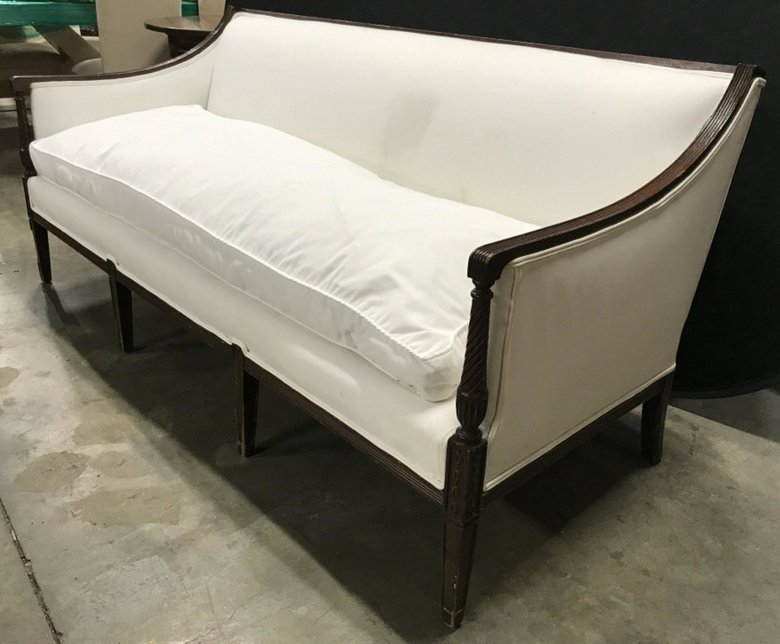 Vintage Sheraton Style Wood Framed Sofa: Vintage Federal style, Sheraton style wood framed sofa with white tone upholstery and loose cushion. Measures approx 32 inches in height by 72.5 inches in width by 29 inches in depth. Sofa have surfac