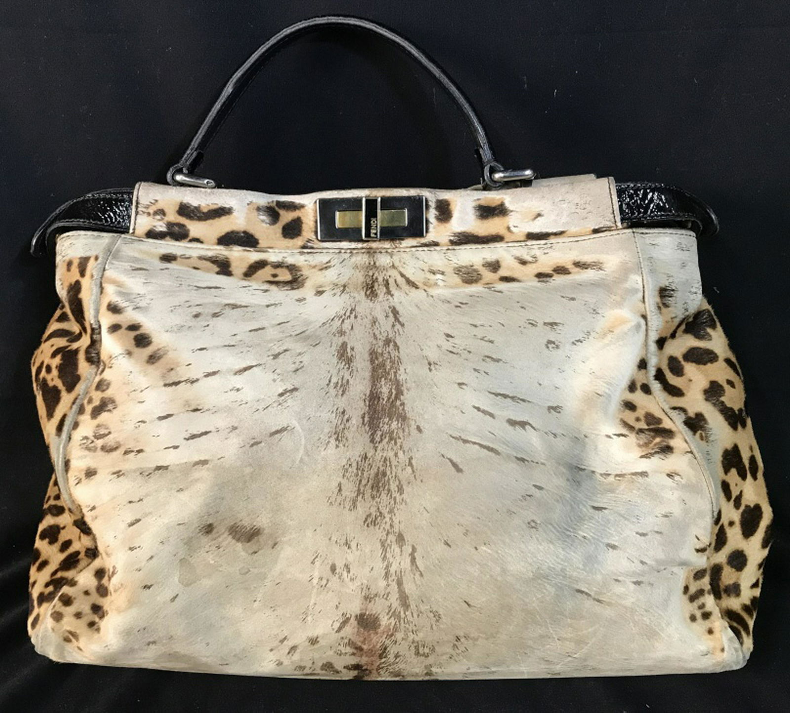 FENDI Peekaboo Printed Pony Hair Bag: FENDI Peekaboo Bag Printed Pony Hair, crafted in brown printed pony hair in leopard patterned design, features a flat patent leather top handle, protective base studs, and silver and gold-tone hardwar