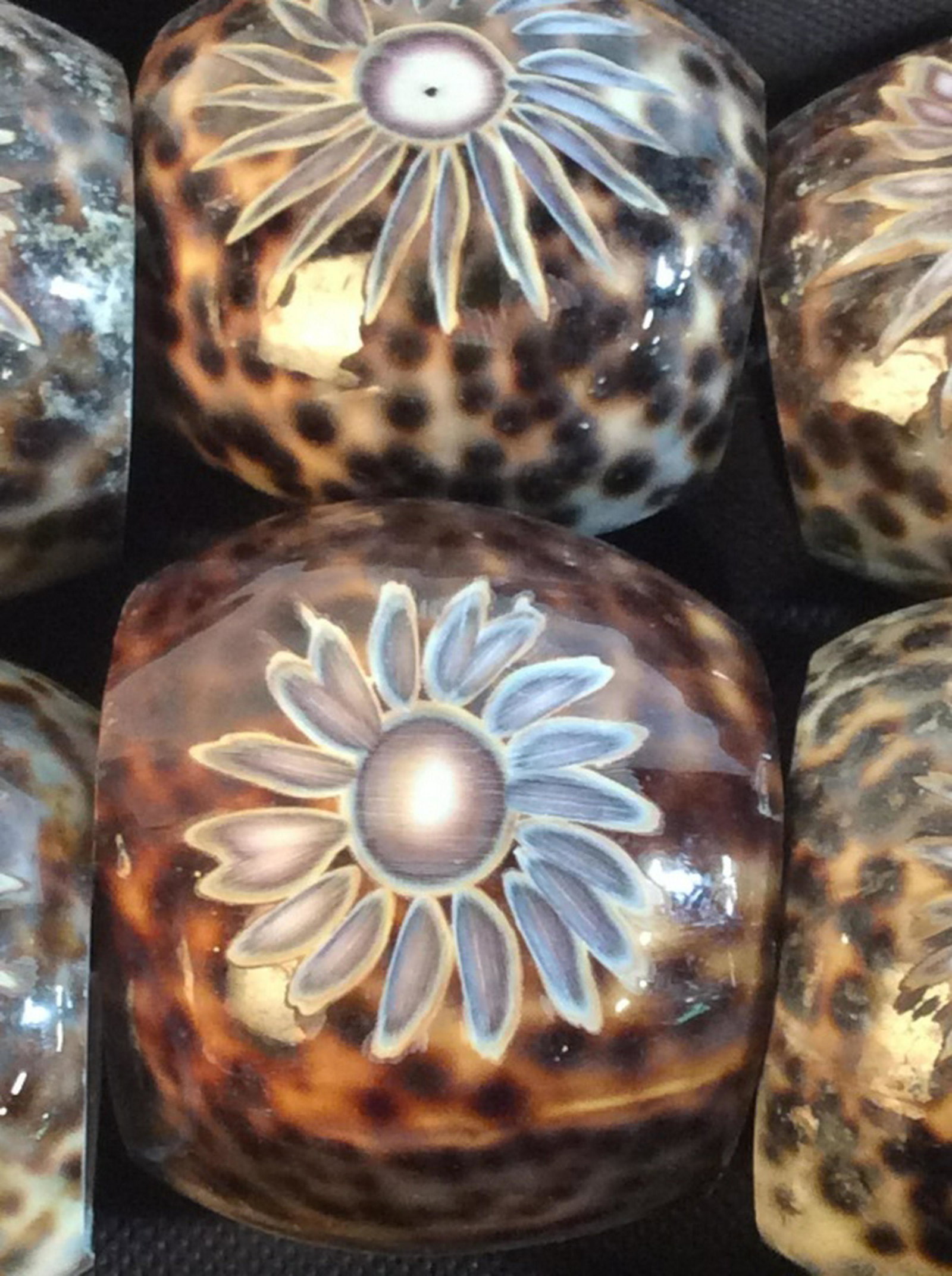 Set 24 - Carved Tiger Cowrie Shell Napkin Rings: Comes in 4 stow away boxes. Sunflower carving design into wide ring. Size varies due to nature! Example insert measurement 1 1/8 x 1. Some a bit smaller. Possibly Never Used. Dinner Decor, Napkin Ring