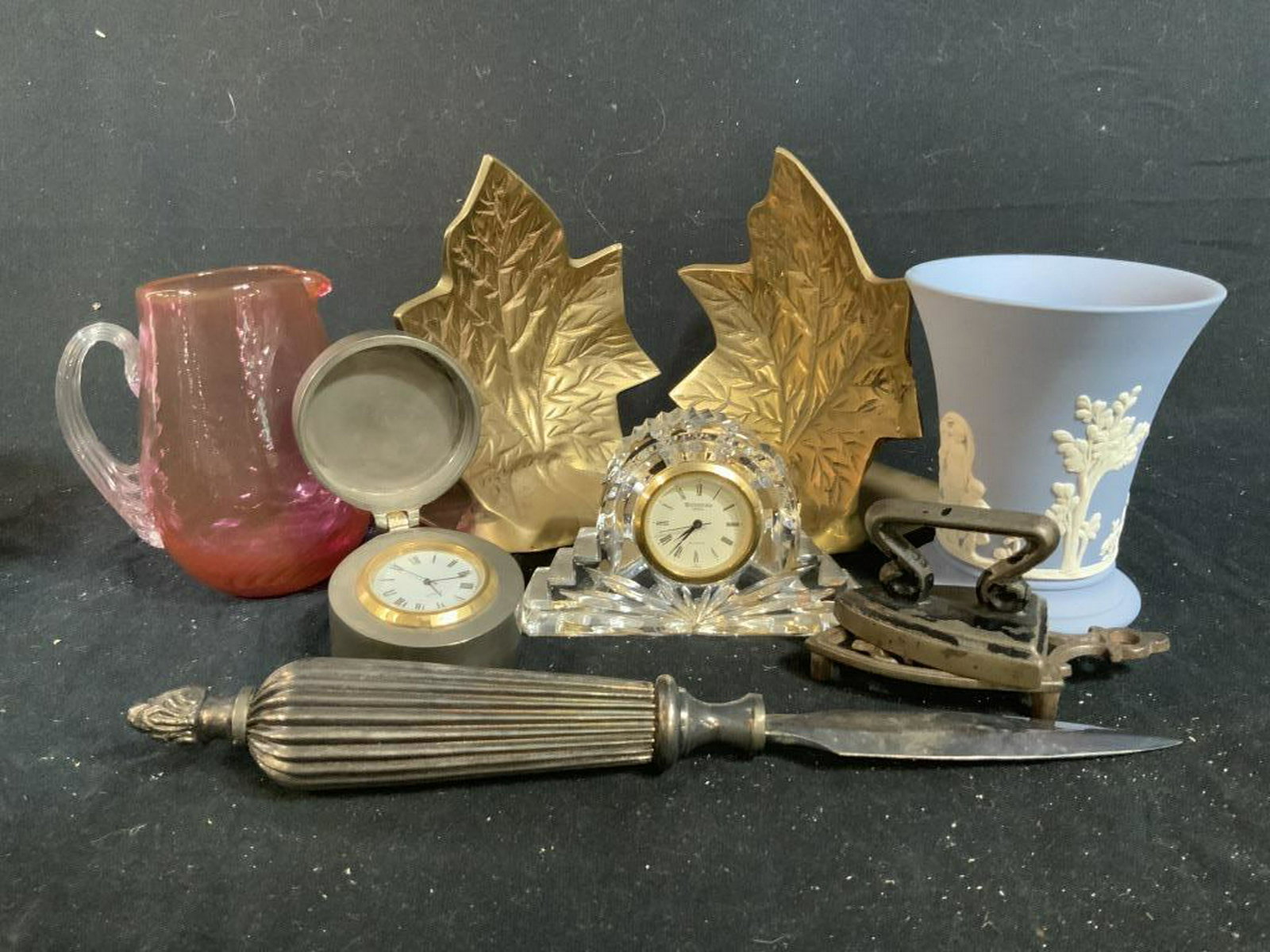 Group Lot Desk Accessories: Group Lot of Desk Accessories includes Cranberry Glass Pitcher, Metal Iron on iron stand, Wedgwood England cup, Waterford Crystal desk clock, pewter lidded Encased Travel or desk clock, brass leaf boo