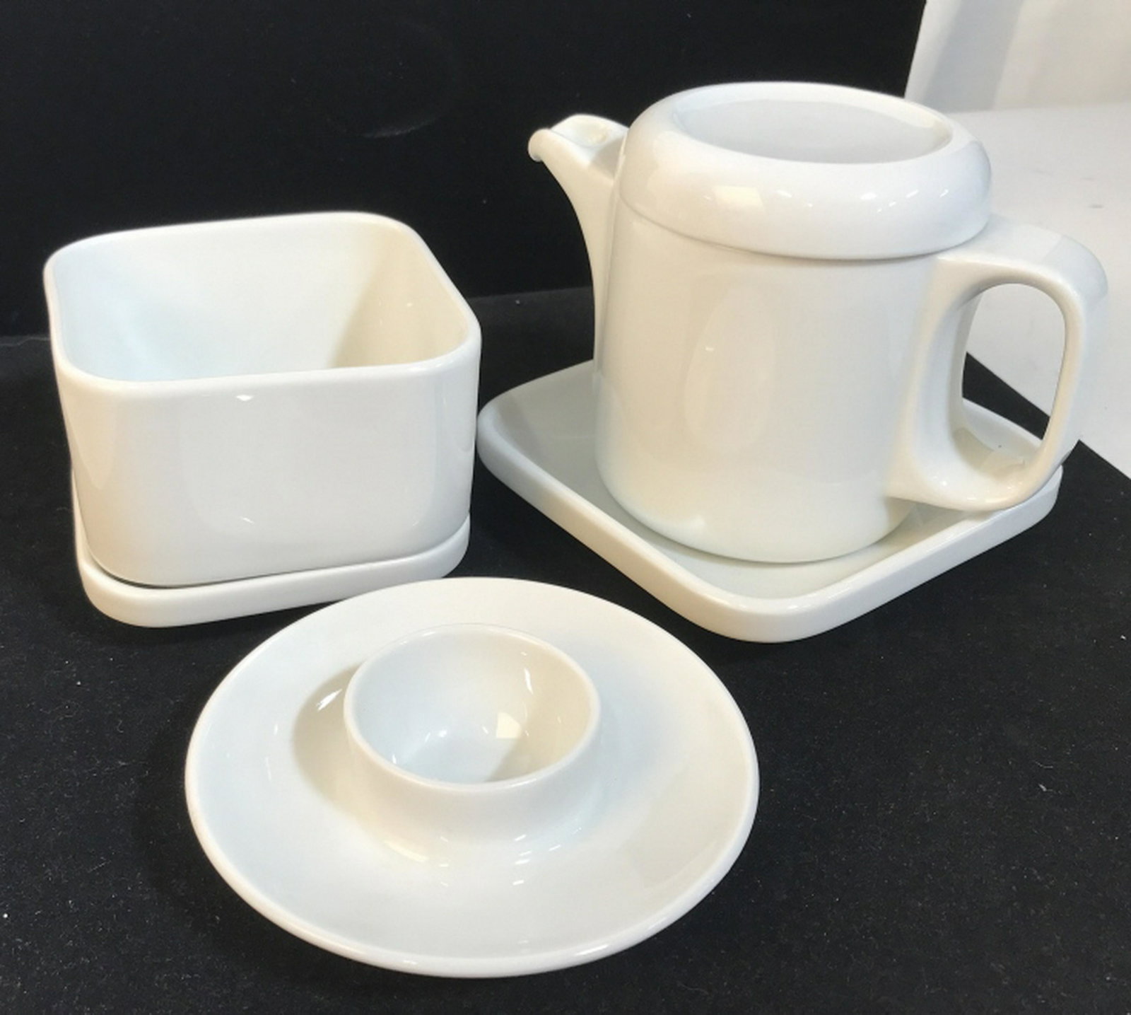 Lot 6 pcs Schonwald German Porcelain Tableware: Personal Tea Pot with Lid and Resting Plate (3 pieces Total) 1 Candle Holder, 1 open sq. Tea cup/ bowl with saucer (2 pieces). All in off white porcelain. Hallmark on undersides. No chips. schonwald T