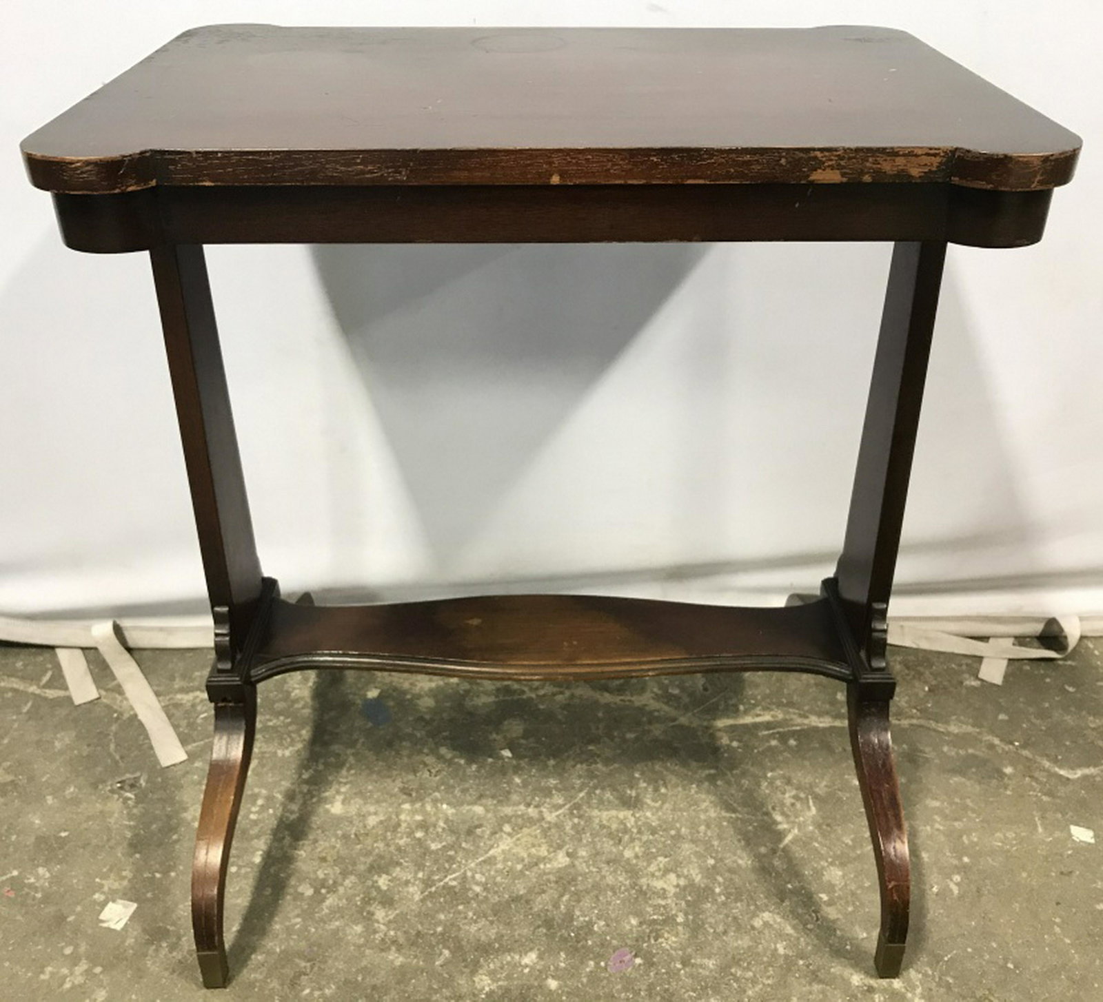 JOHN A COLBY & SONS Carved Wood Table: Piece has a mahogany brown. Piece measures approx. 23 inches wide 26 inches tall 16 inches deep. contains evident scratches and wear. Support legs need repair. side table, end table lamp table living 