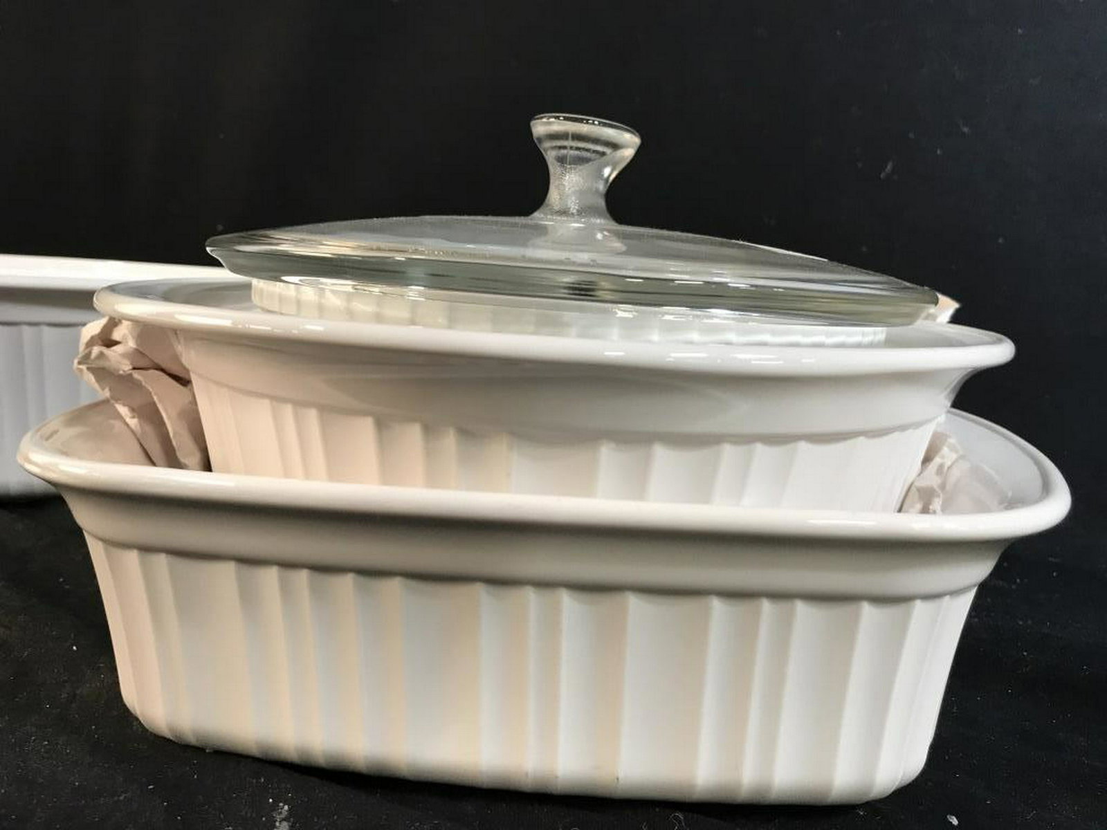Group Lot of Corning Ware Ceramic Serve Ware: Serving dishes, cooking dishes, white toned ceramics, largest oval measures 16 inches length ht app 4 inches, some with lids, 10 pieces total