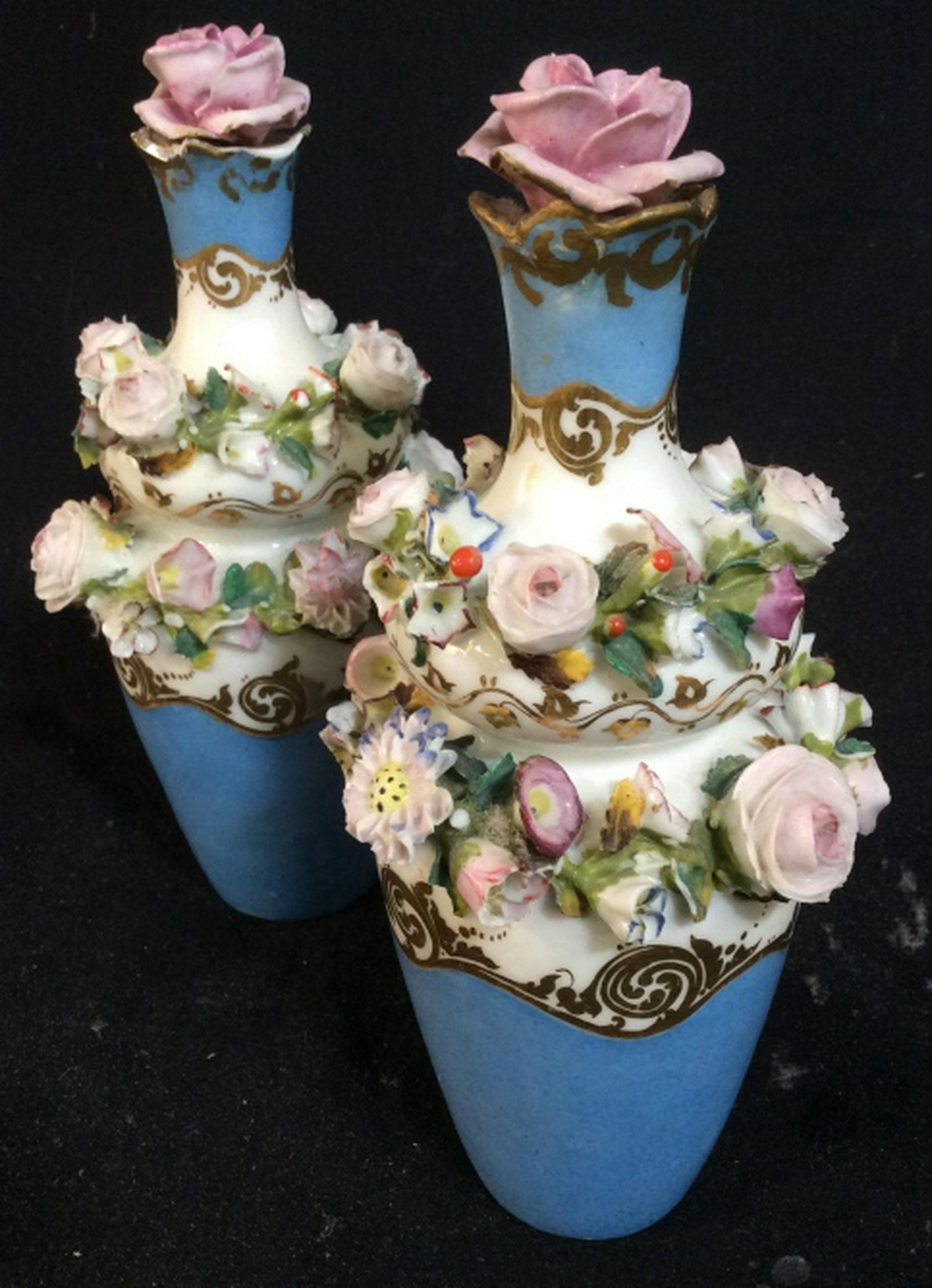 Antique Floral Decorative Vessel Set of 2 antique: Set of 2 antique decorative floral vessels. Roses are detached from the base and some petals are chipped. Glass flowers protrude from the levels of the vessel. Painted blue with gold accents. Measures