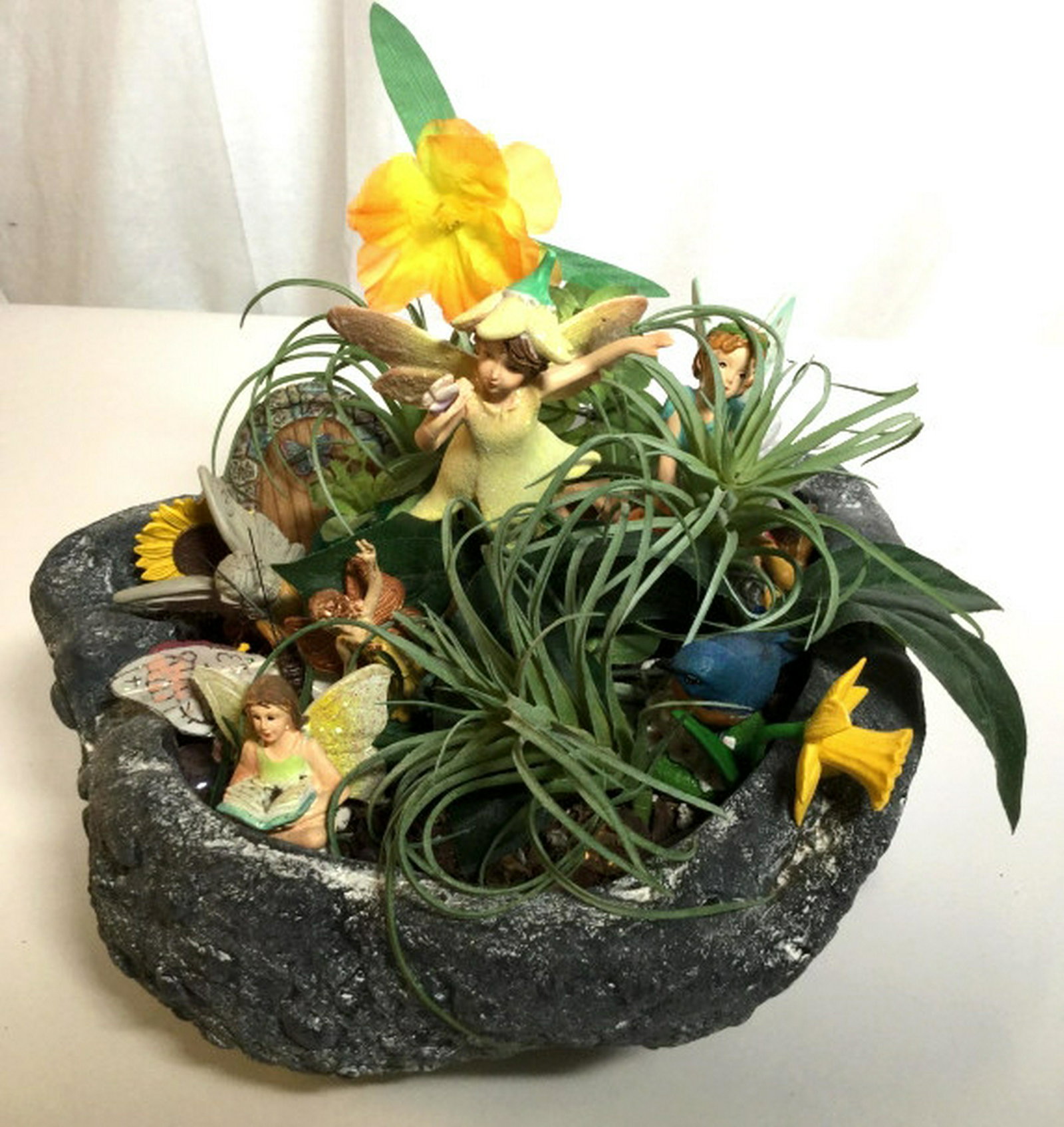 Outdoor Fairy Garden Decorative Accessory Outdoor fairy: Outdoor fairy garden in stone style planter, complete with approximately 20 pieces. Pieces include faux plants, rocks, fairies, gnomes, flowers, butterflies, etc. decorative accessory, tableware, cent