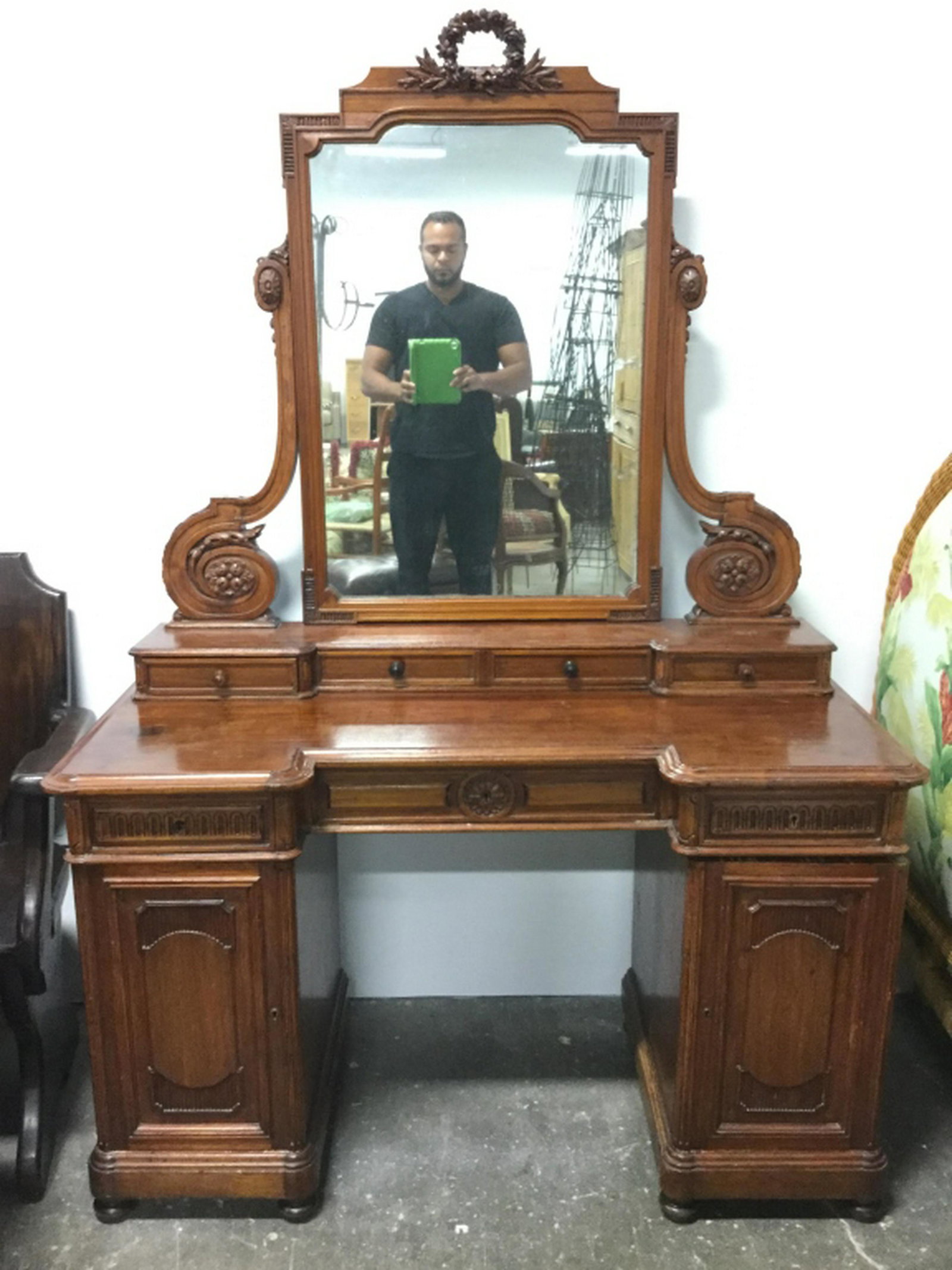 Antique Carved Russian Vanity Desk Piece has intricate: Piece has intricate carved wooden detail including floral, & leaf detail. Piece has carved wooden feet. Piece has 4 small drawers on top, 3 drawer in Middle with key holes and 2 cabinet doors with key