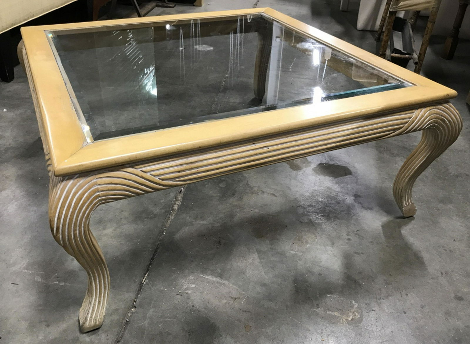 Carved Wood Coffee Table W Glass Top Insert Carved: Carved Light tone wood wood base with beveled glass top. Measures approx 15 inches in height by 36 inches squared in length and width. Some minor surface wear of coffee table, including light scratche