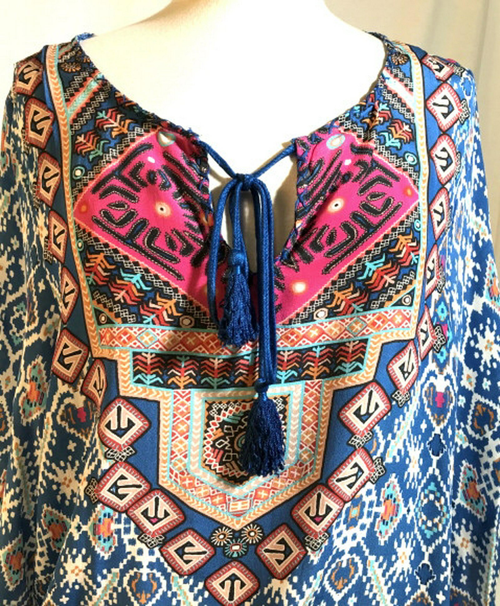 TOLANTI. Patterned Bathing Suit Coverup w Tags Size: Size Large with 3/4 sleeves and front tassel tie. Soft material, possibly silk. 33 in. long from shoulder to hem, Sleeve- 21 in. Long. Hips- 36 in circumference. 2 in side slits. No rips, pulls, marks