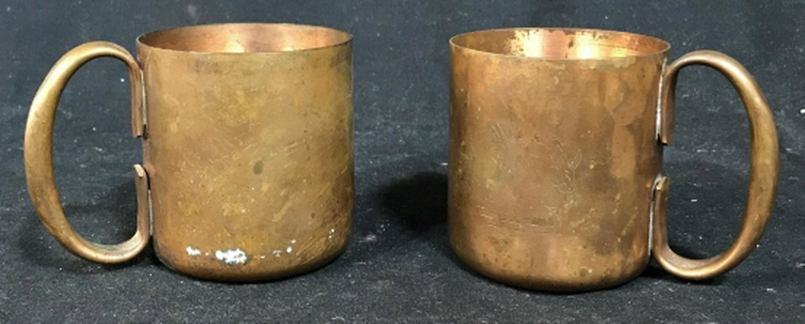 Pair of copper Toned Metal Mugs Possibly copper set of: Possibly copper set of 2 mugs. Each mug measures approximately 3.5 inches in height. Set of mugs, vintage mugs. tableware, drinking mugs, vessels, 5