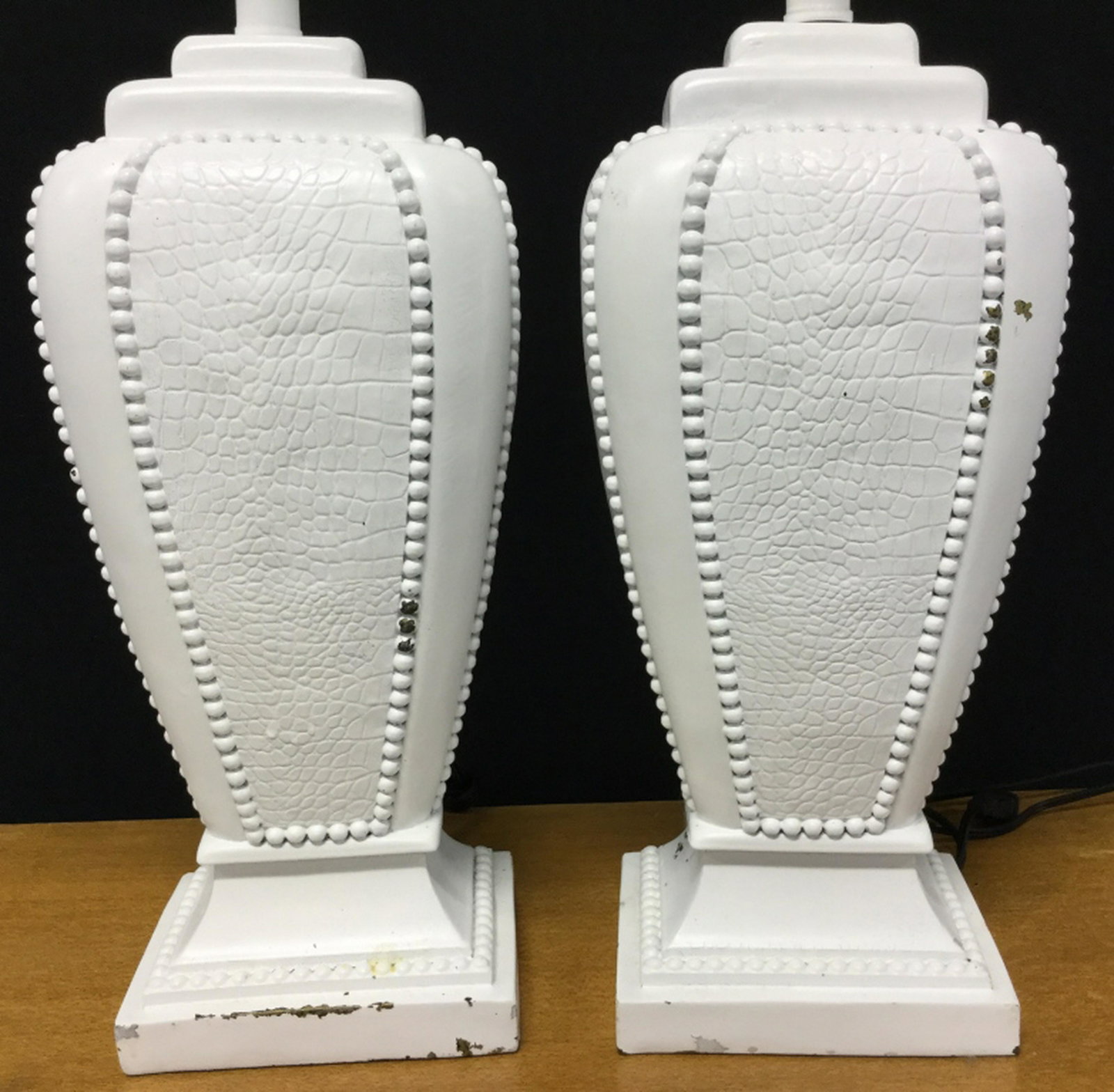 Pair White Tone Leather Style Table Lamps Table lamps: Table lamps are made to appear as crocodile leather, white in tone. Lot does not include lamp harps. Lamps have not been tested. Lamps measure approx 21.5 inches in height by 6.75 inches in width by 5