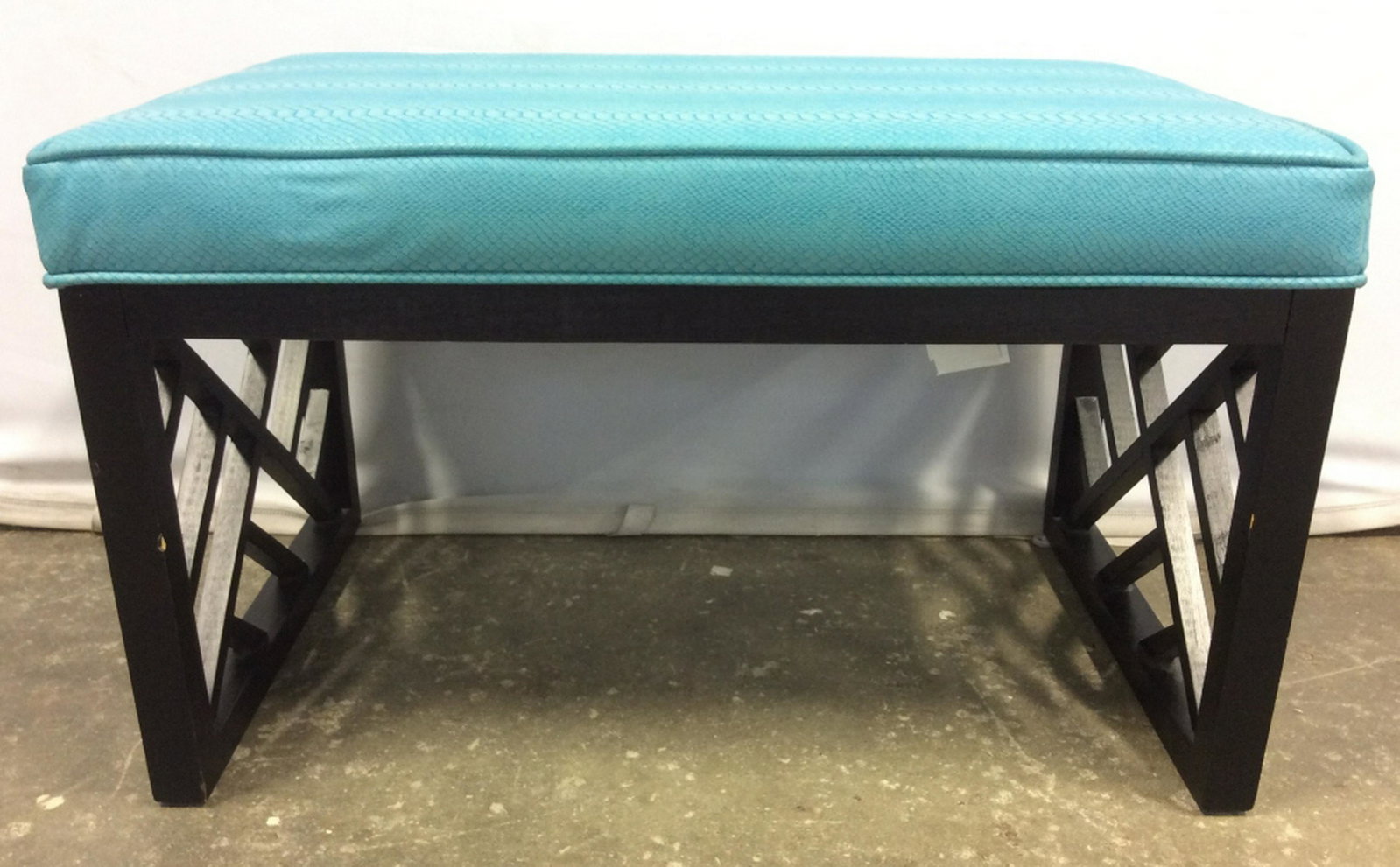 Aqua Toned Cushioned Bench Bench’s seat cushion is aqua: Bench’s seat cushion is aqua toned. Bench’s support appears to be wooden and is black toned. Measures approx 30 inches long 18 inches deep and tall. Home accent and furnishings, window bench, benc