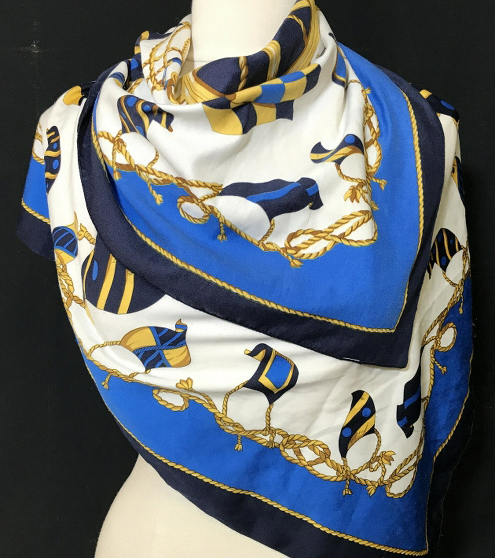 Nautical Motif Silk Scarf Ships Wheel Motif Scarf, 33 x: Ships Wheel Motif Scarf, 33 x 34 1/4 approx. Helm is the center feature with winding ropes and flags. Some light marks from use, a little silk thread pulling noticeable. Ships Wheel Silk Scarf, Nautic