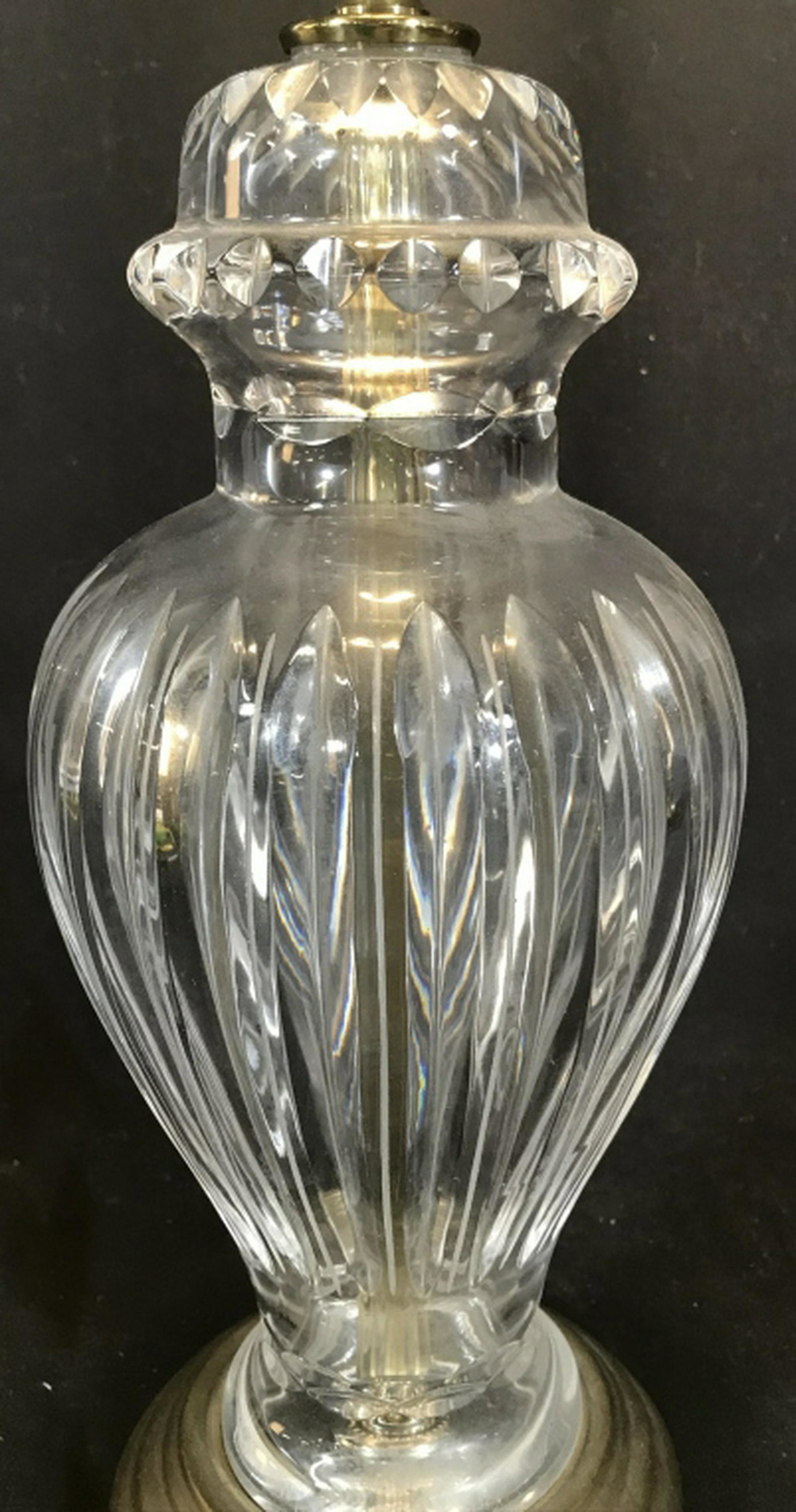Cut Glass Body Table Lamp Vintage lamp has footed brass: Vintage lamp has footed brass base and you can see the interior tube through the glass. Harp attachment, no shade or finial. Appears to be a 3 way switch for lighting, not verified from bulb that is p