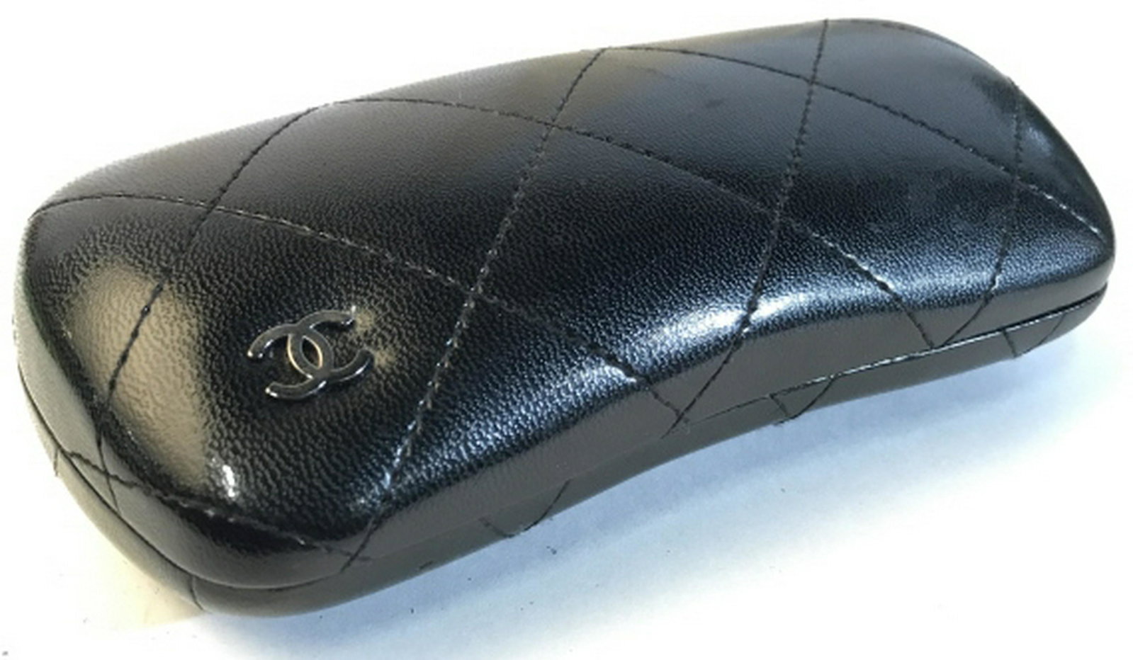 CHANEL EYEGLASS CASE BLACK Chanel eyeglass case in: Chanel eyeglass case in black. Quilted design on the front with Chanel logo present. Case measure at approximately 6.5 inches in length. Case has made in Italy stitched on the inside along with tag in
