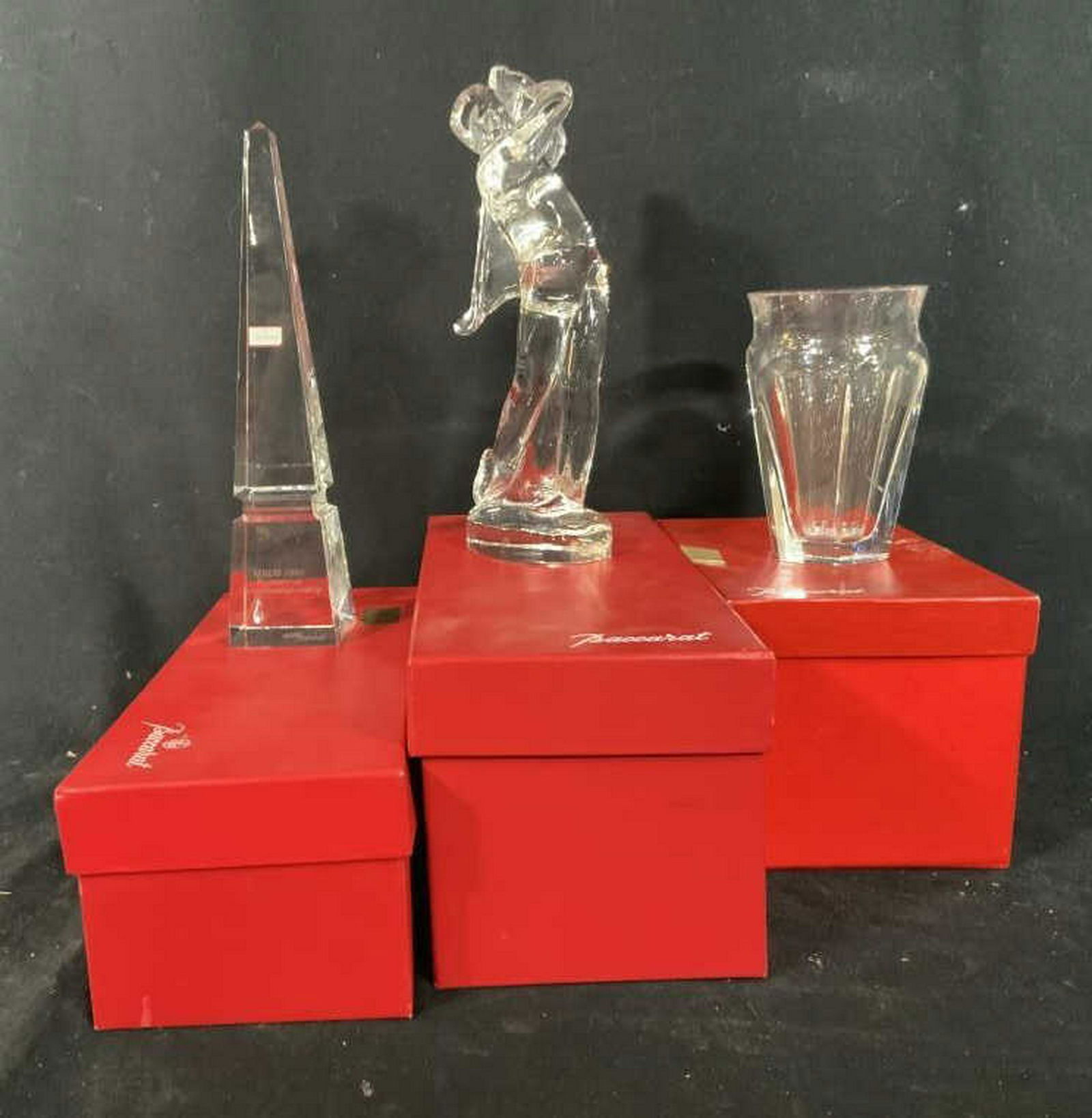 Three Boxed Baccarat Vessels, one Monogrammed Each: Each baccarat vessel as trophy in original box one obelisk ht app 10 inches Etched for champion ship, one golf Figural app htb10 inches and vase app ht 5 inches, luxury crystal, luxury tableware, coll