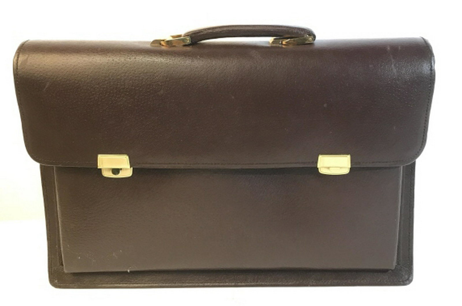 17 inch vintage Genuine Leather briefcase 17 inch: 17 inch Genuine leather briefcase made in China. Dark brown color with gold colored hardware. Some of the original stuffing still in the briefcase. Some scratches on the top of the case. Features 4 po