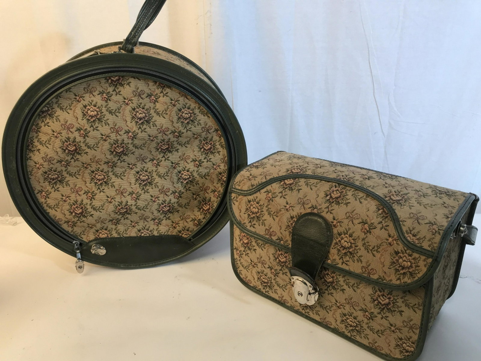 Pair Vintage Floral Suitcase Vintage Floral Suitcase: Vintage Floral Suitcase with green accent pair. Each bag still has luggage tags in tact. Quilt work done on the inside of the circular bag. Staining is evident on the inside of both bags. Circular bag