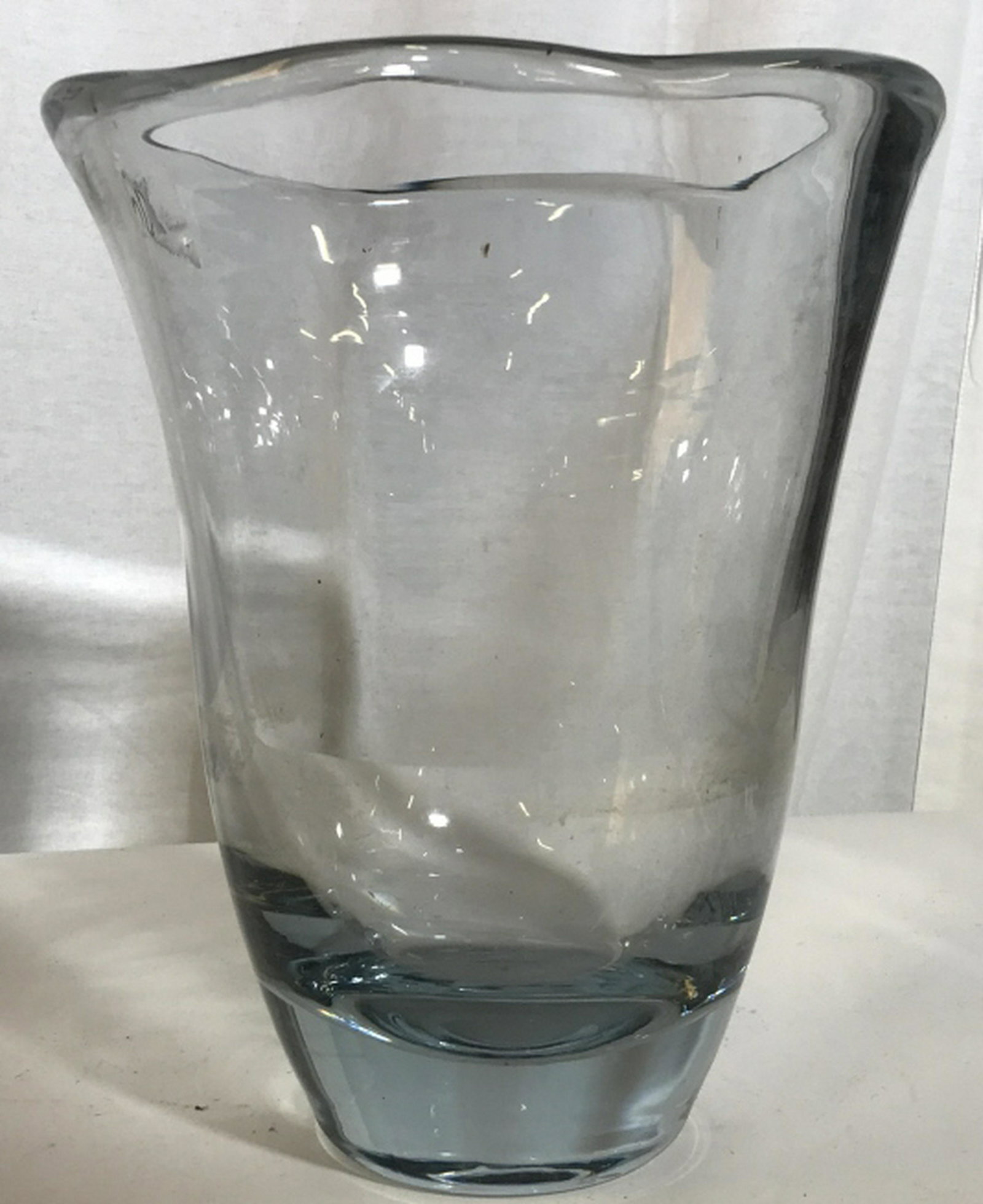 Romantic Grey Rutile Crystal Vase Grey Ocean Blue Hue: Grey Ocean Blue Hue with Soft Edges. This crystal vase has a thick body with a wavy rim & heavy weight. No chips or scratches. Mild normal use. Height 10 in. Rim circumference 24 in. Base, just under 