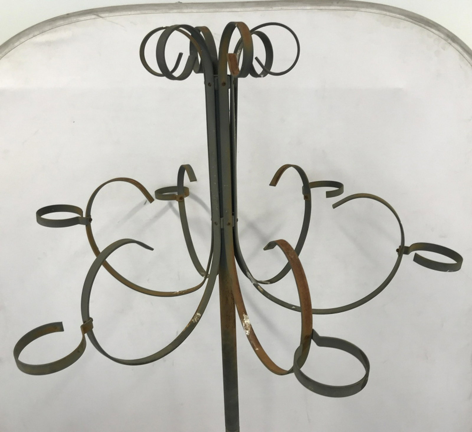 Tall Iron Metal Planter / Lantern Holder Stand Tall: Tall iron metal stand has 6 outstretched arms with ring ends, possibly for holding planters or lanterns. Structure measures approximately 81.5 inches in height by 40.5 inches in diameter. Stand has su