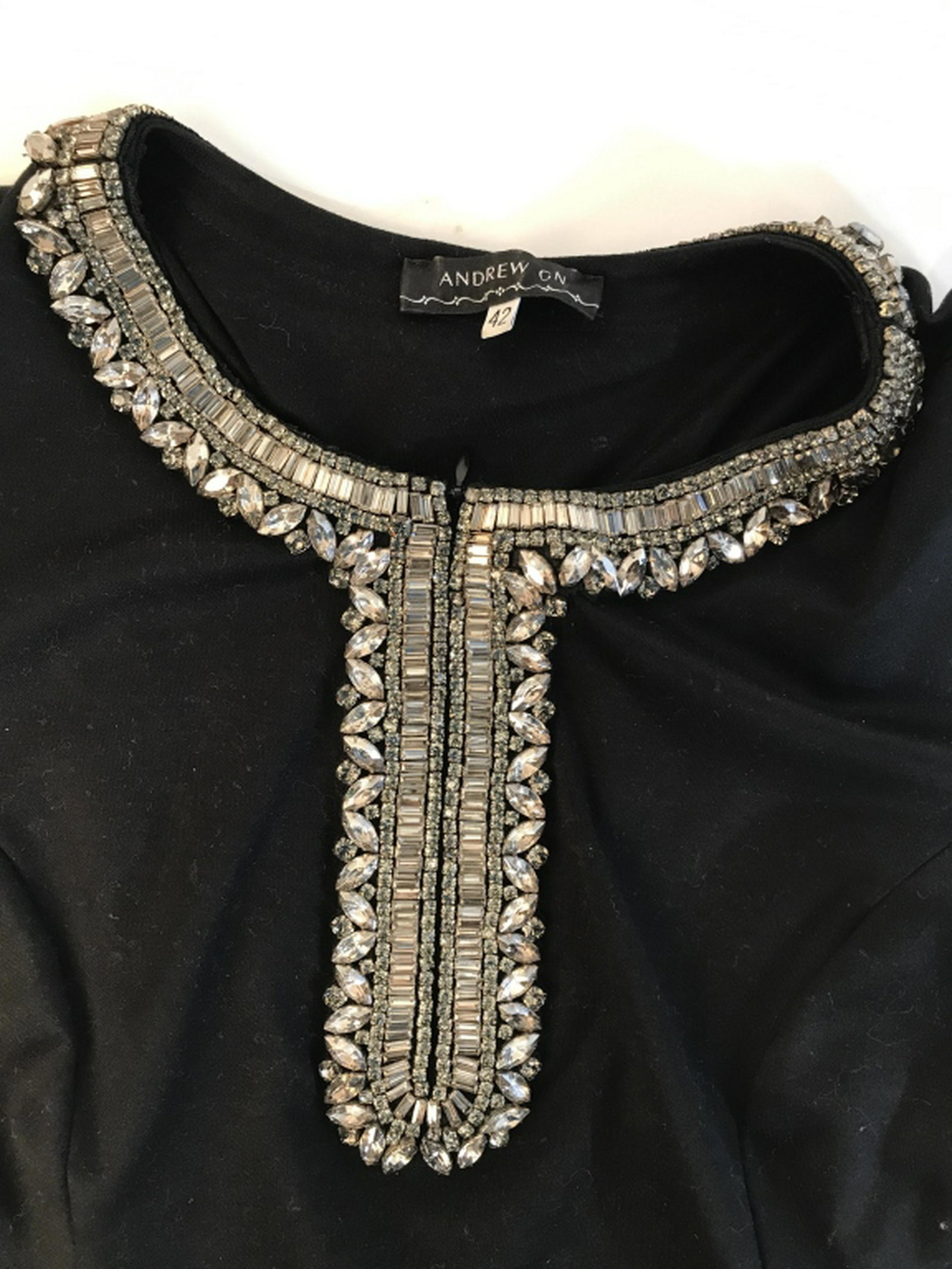 MADE IN FRANCE ANDREW GN decorated black shirt Andrew: Andrew GN decorated black shirt. Size 42. Heavy beading sewn into collar area. Short sleeved shirt. Materials: 99% cotton, 1% glass beads. Made in France. Tapered waist and zipper Closure for Chest Ar