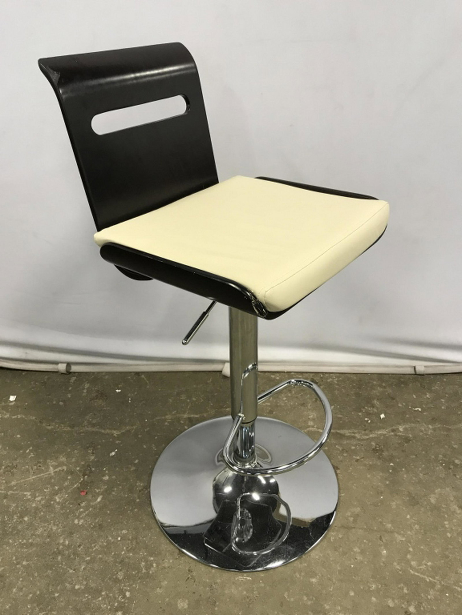 Adjustable Wood & Chrome Bar Stool Adjustable bar stool: Adjustable bar stool with white tone leather-style upholstery and curved wood-style frame. Seats sit atop chrome base. Lever for adjusting and foot rest. Measures approx 36 inches in height by 16.5 in