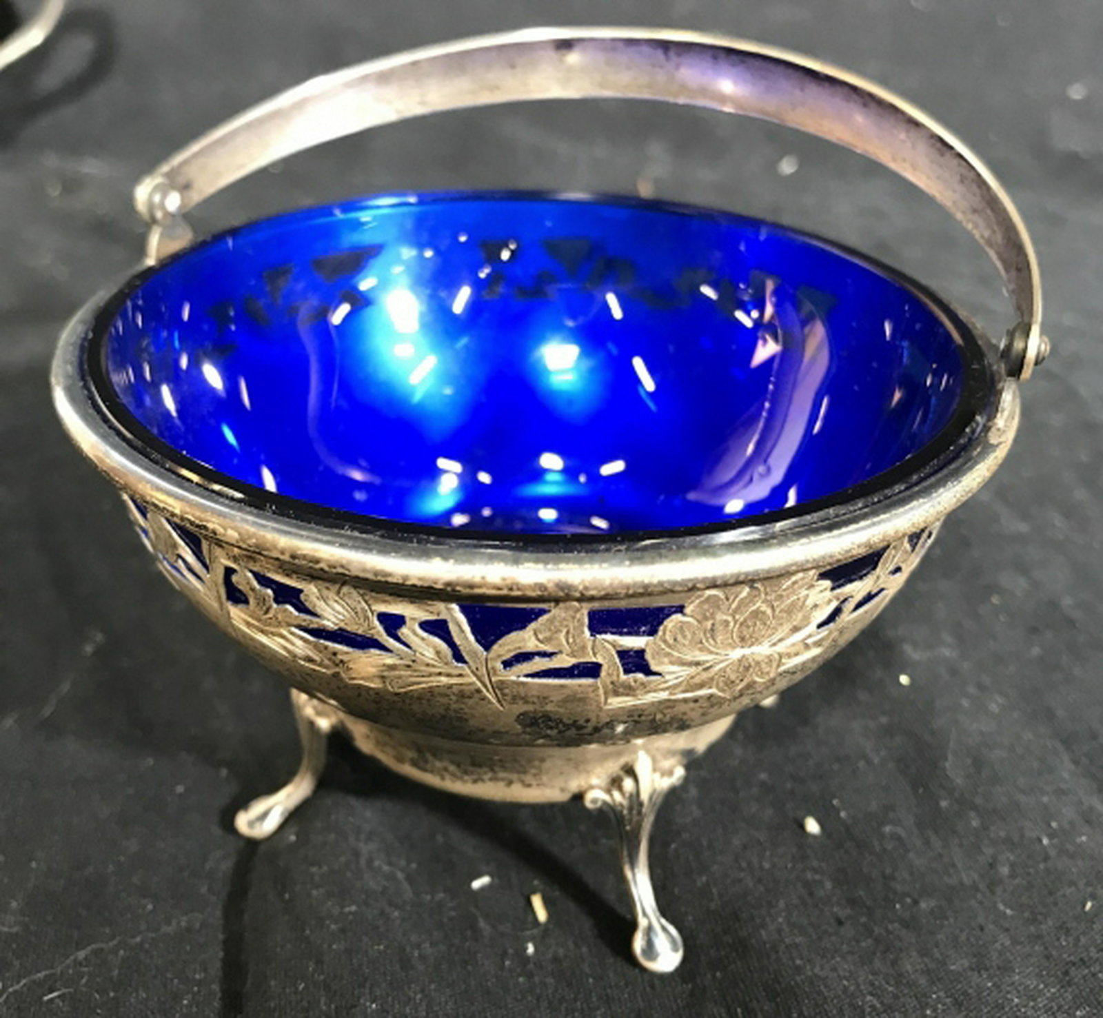 Sterling Silver Cobalt Blue Glass Basket Bowl Art: Art Nouveau Sterling Silver Bowl With Four Feet, open work design of floral and vines, moveable basket handle, marked underside for Sterling Silver, trademark illegible, Sterling Silver Table ware, co