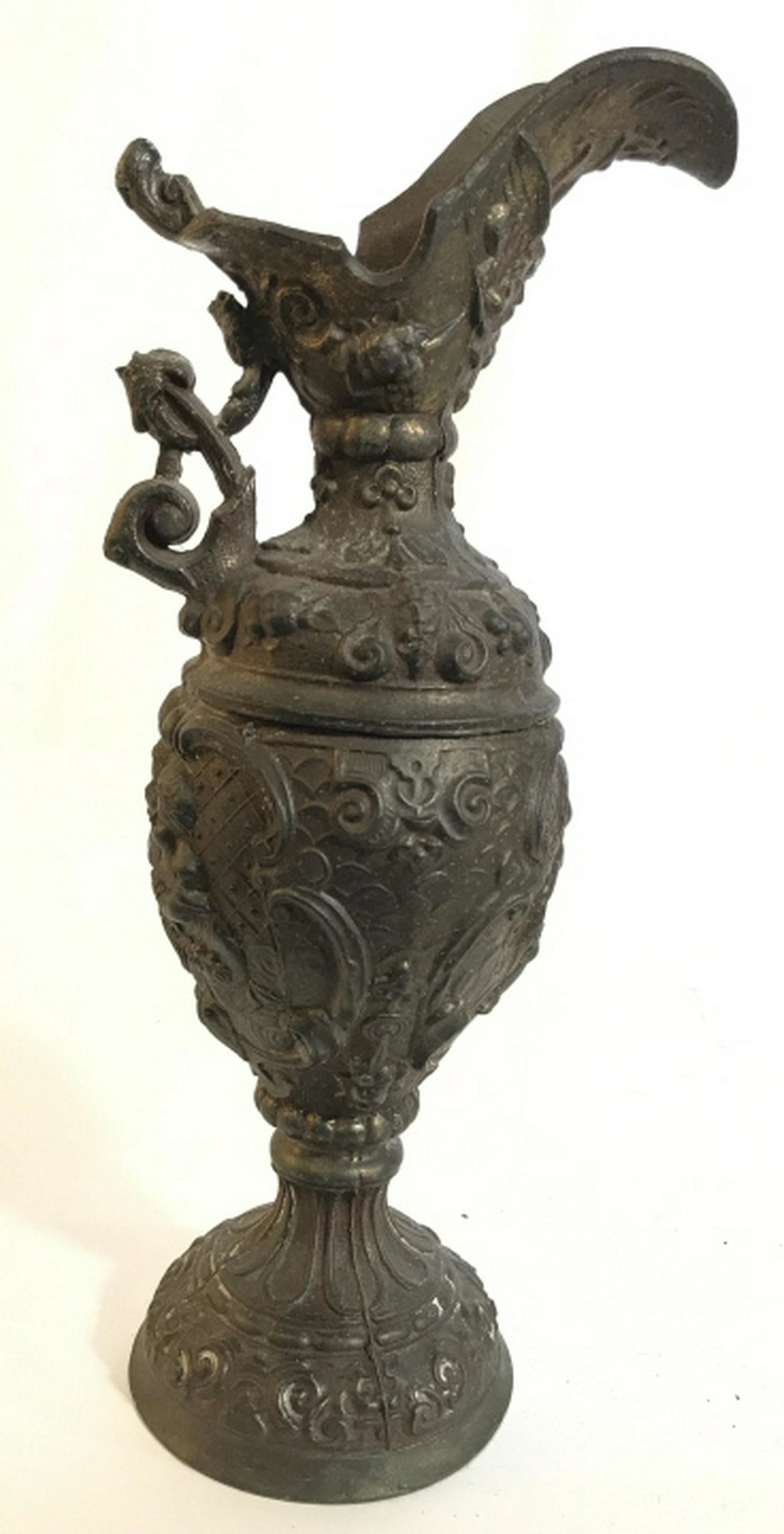 Ornate Metal Vessel w Puttis Cherubs angels swags and: Cherubs angels swags and swirls in Relief, Footed Pitcher, Jug, Vase, Vessel, tableware, Metal Possibly Bronze, Measures ht app 11.5 inches handle to rim app 6 inches