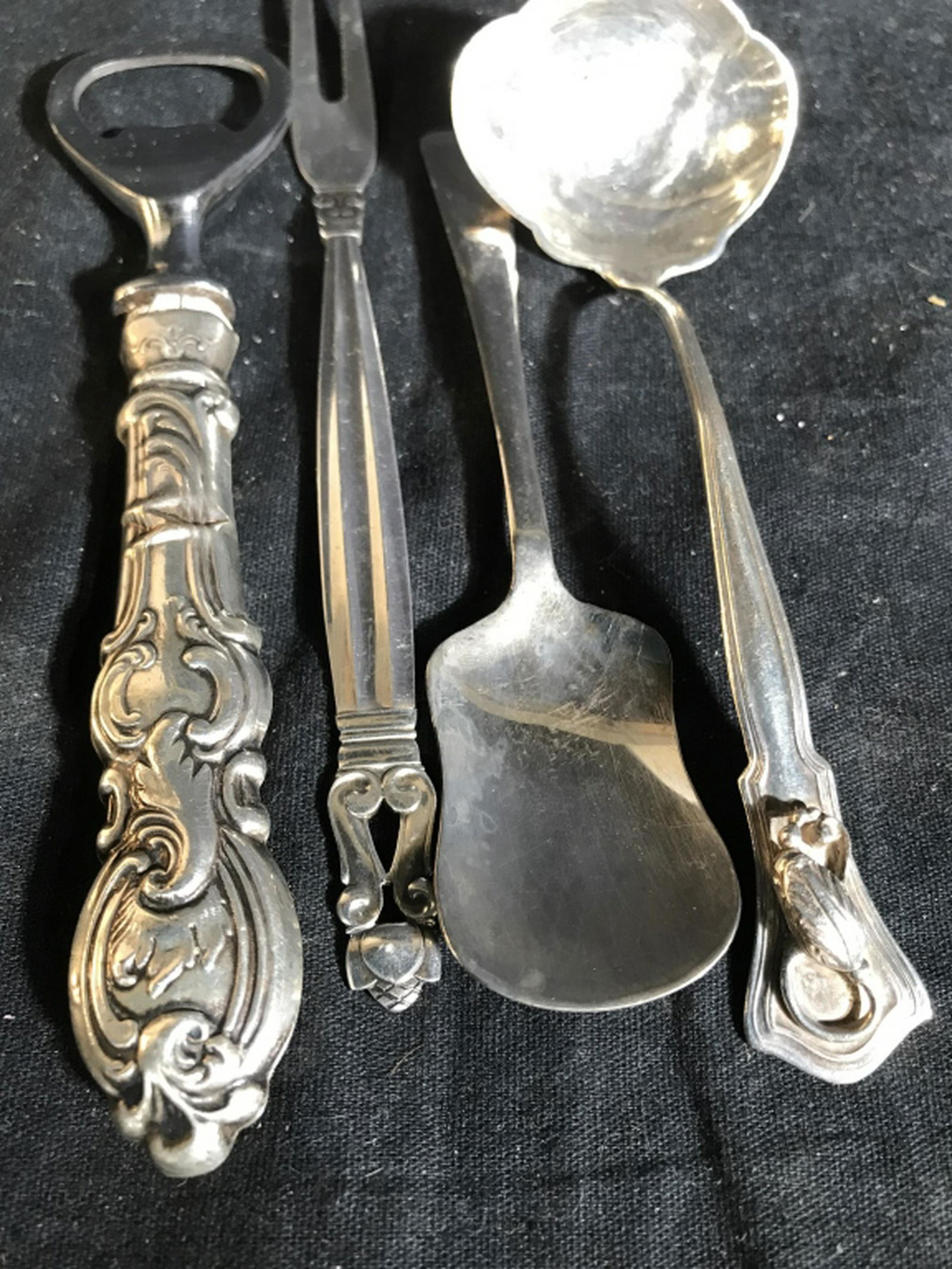 4 Sterling Silver Serving Utensils Sterling silver: Sterling silver fork, two spoons, and sterling silver can opener, length of fork app 7 inches, serving utensils, flatware