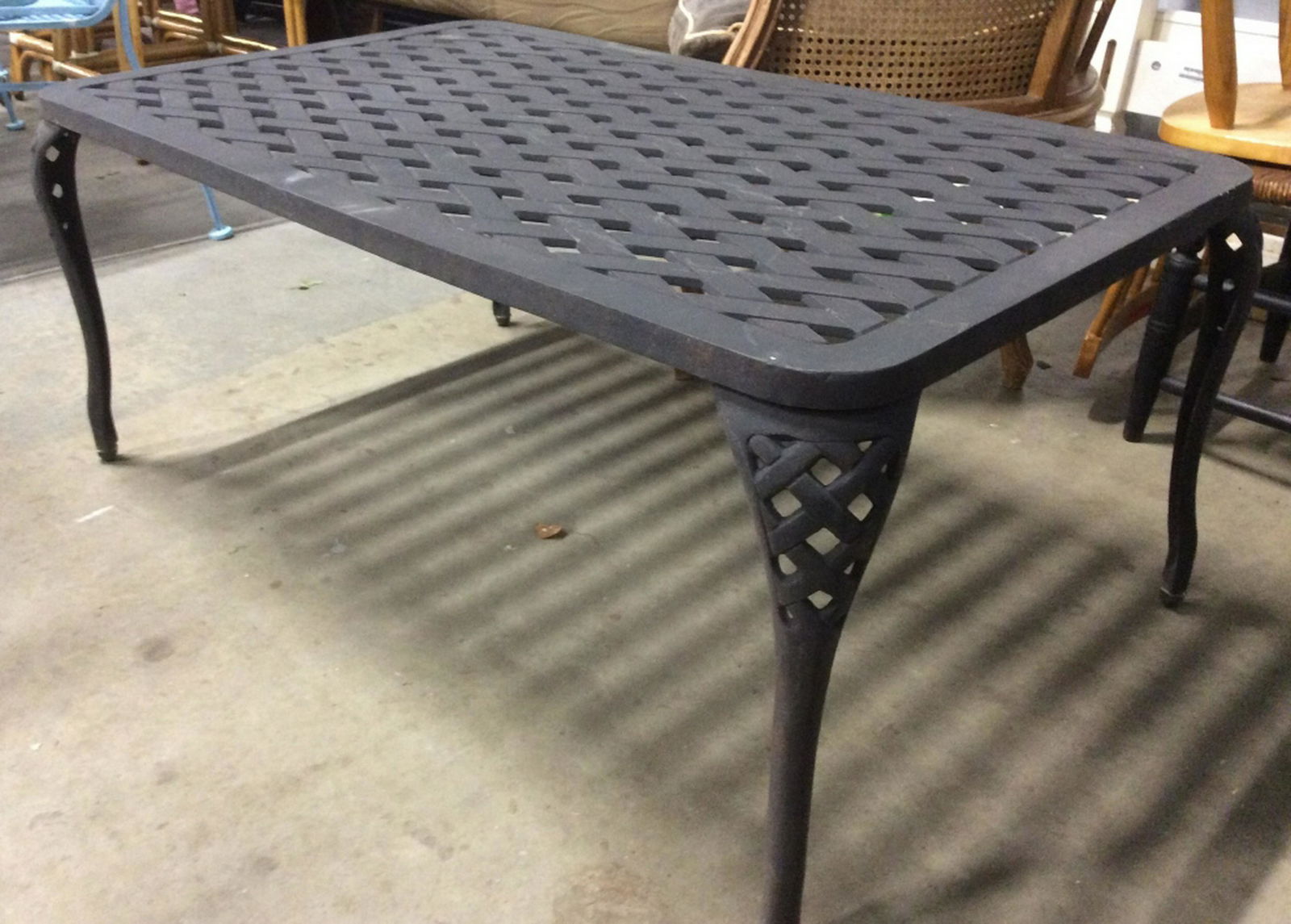 Outdoor Black Toned Metal Table Table is black toned: Table is black toned and metal. Contains detail that mimics weaving. Outdoor table, coffee table, patio table, metal table. Measures approx 43 inches long, 26 inches deep, 18 inches tall. 6.